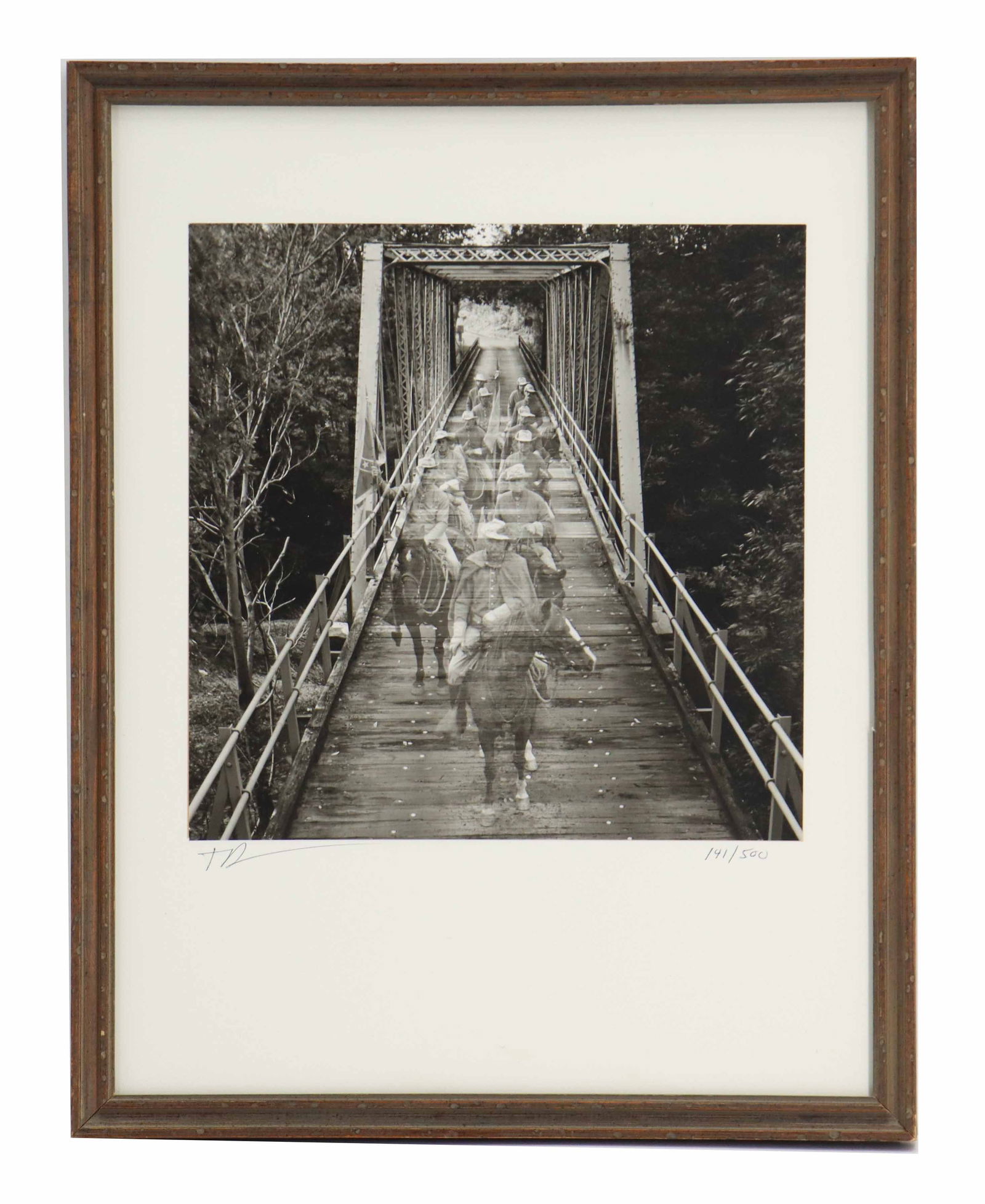 Superimposed Photograph of Soldiers Crossing Bridge: Superimposed Photograph of Soldiers Crossing Bridge. Back and white photograph depicting a line of figures on horseback, possibly soldiers or riders from a historical re-enactment, crossing a rustic