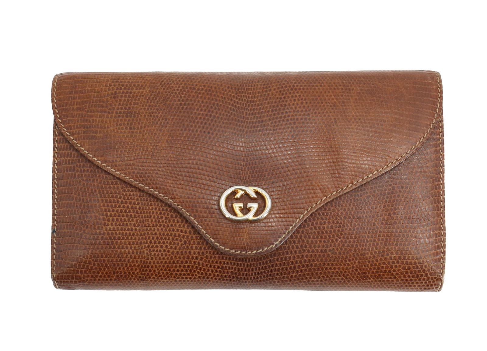 Vintage Gucci Lizard Skin Clutch: Vintage Gucci Lizard Skin Clutch. Features prominent interlocking G logo closure on the front flap. Designed in a sleek frame silhouette. Gold-stamped "Gucci, Made in Italy" signature locate