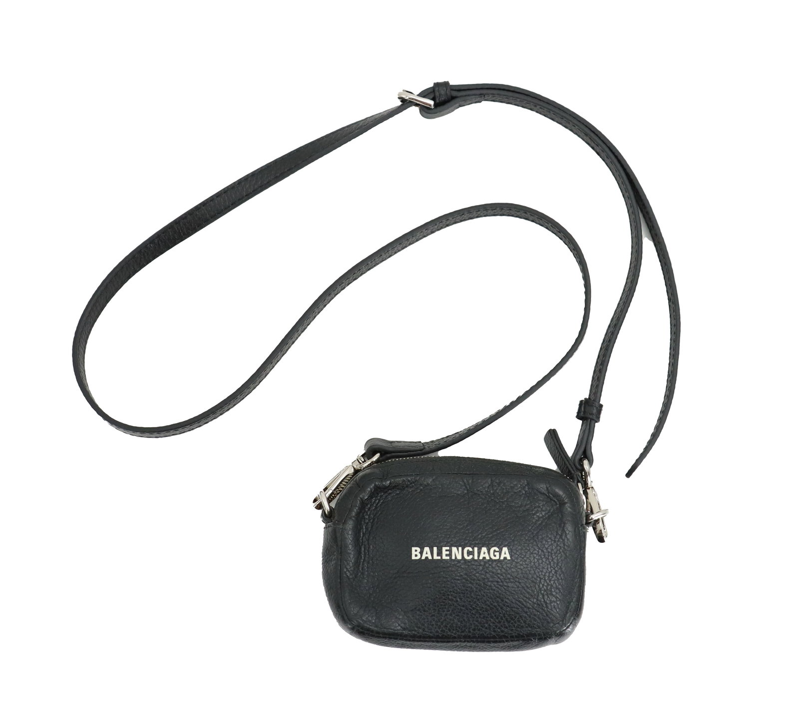 Balenciaga Cash Mini Pouch: Balenciaga Cash Mini Pouch. Compact, camera-style crossbody bag crafted from black grain calfskin leather. Thin, adjustable, and removeable leather shoulder strap. Interior lined with black leather wi