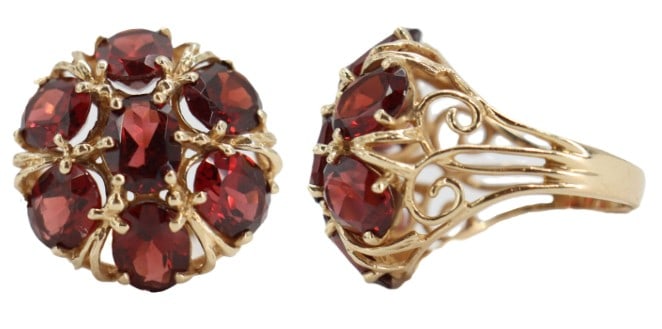 One Marked 10k Gold and Garnet Ring - Gross 6.2 g: One Marked 10k Gold and Garnet Ring. Marked on inside. 7 oval cut garnets set in yellow gold. Prong setting. Intricate swirl designed band. Garnets set in a flower design. Ring Size: 6.5 Gross W