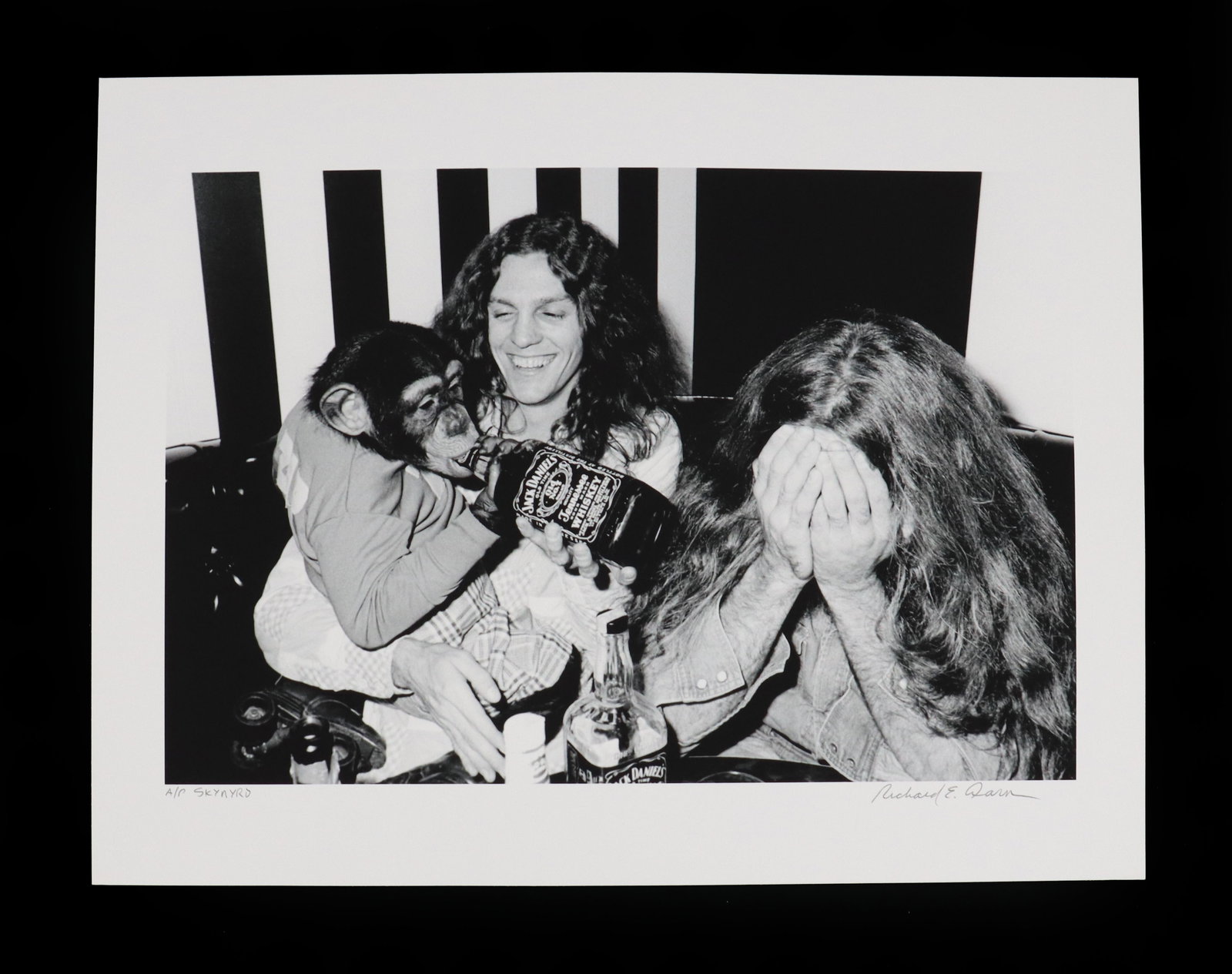 Richard E. Aaron (1949-2016) American, Artist's Proof Lithograph, Lynyrd Skynyrd: Richard E. Aaron (1949 - 2016) American, Artist's Proof Lithograph, Lynyrd Skynyrd. Candid black-and-white photograph depicting members of Lynyrd Skynyrd in a lighthearted moment, featur