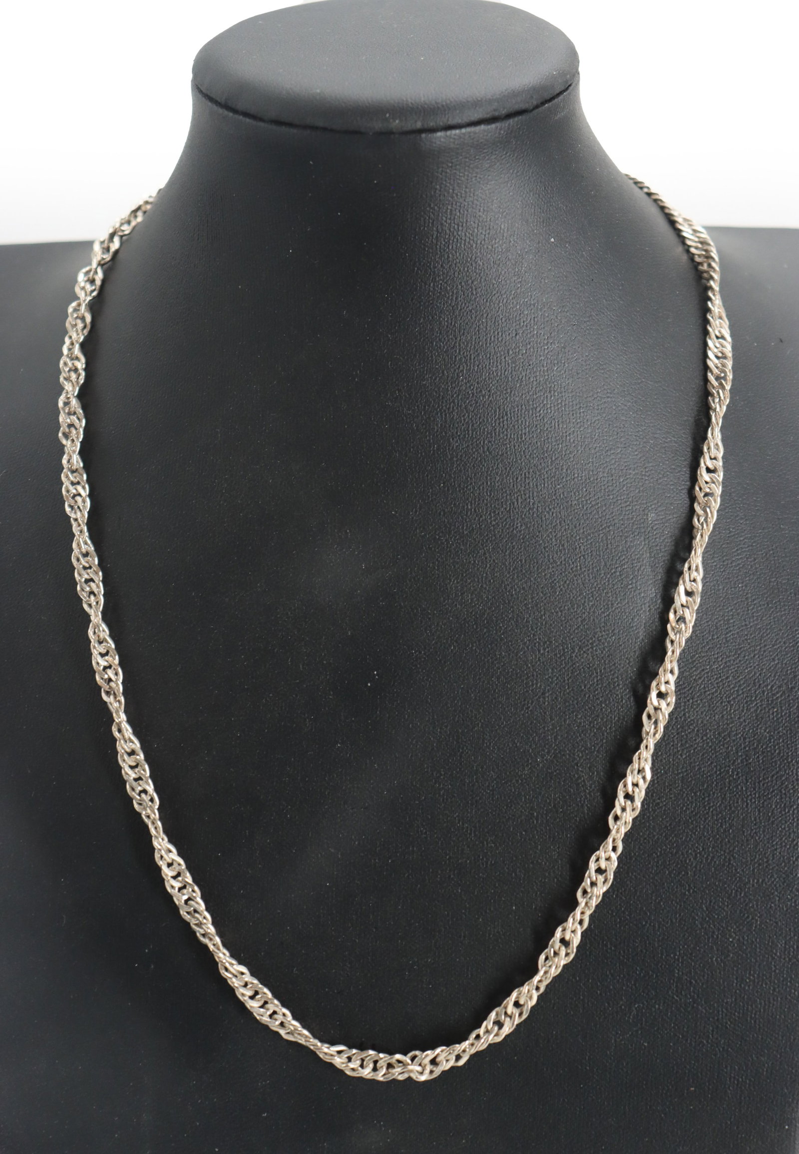 Classic Sterling Silver Rope-Style Chain - 0.675 ozt.: Classic Sterling Silver Rope-Style Chain. Marked on clasp. Featuring interlocking circular links that create a twisted, textured appearance. Length: 20 in.Weight: 0.675 ozt.