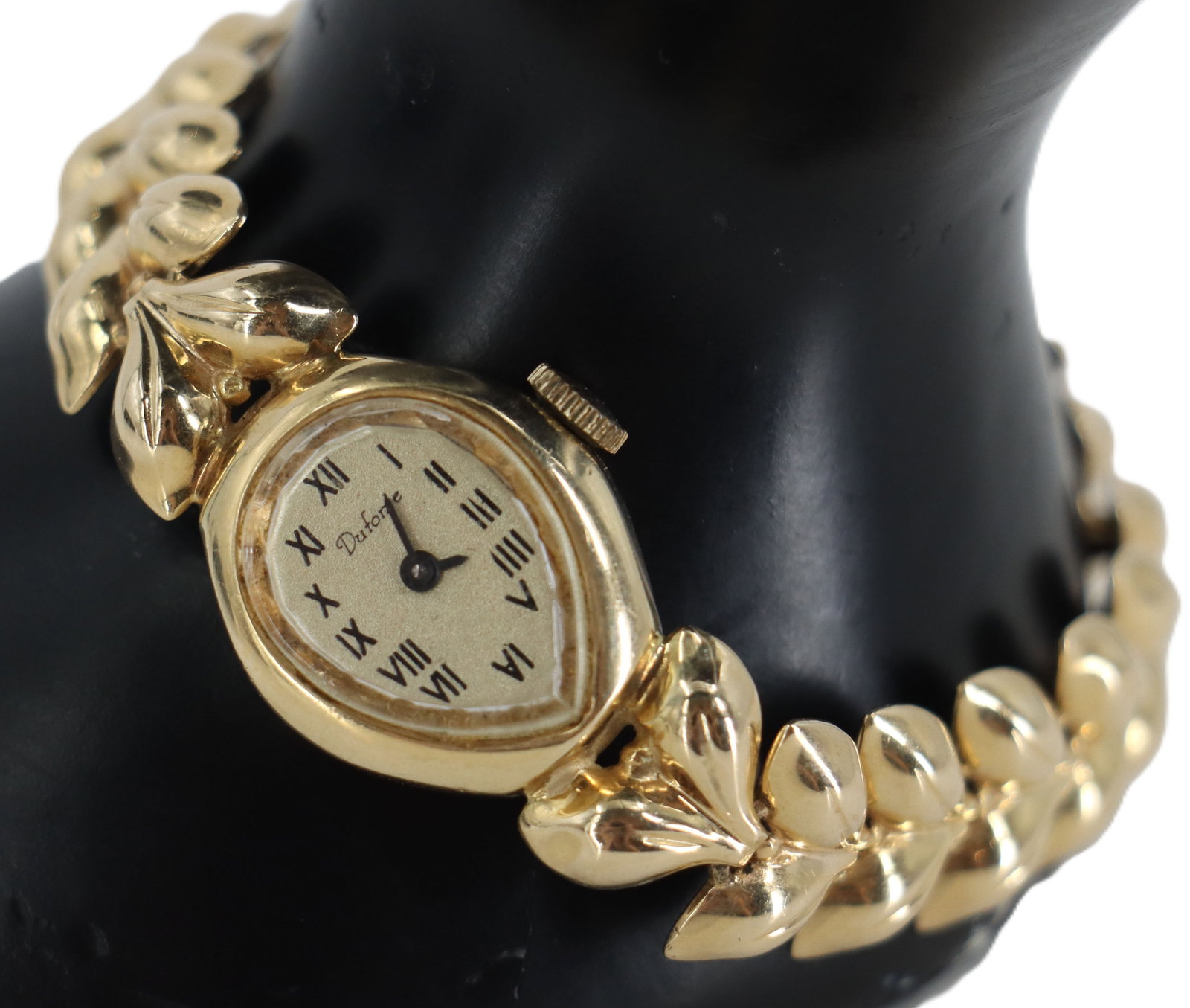 Vintage Dufonte by Lucien Piccard Ladies Wrist Watch: Vintage Dufonte by Lucien Piccard Ladies Wrist Watch. Crafted in 14k yellow gold with a distinctive leaf-motif integrated bracelet. The almond shaped dial features a champagne finish with black Roman