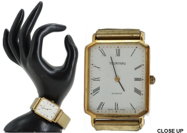 One Gold-Toned Tourneau Wrist Watch: One Gold-Toned Tourneau Wrist Watch. Quartz, Swiss made. Fond Acier Inoxydable, marked on back. Expandable band. Size: 1 x 3 1/4 x 2 in.