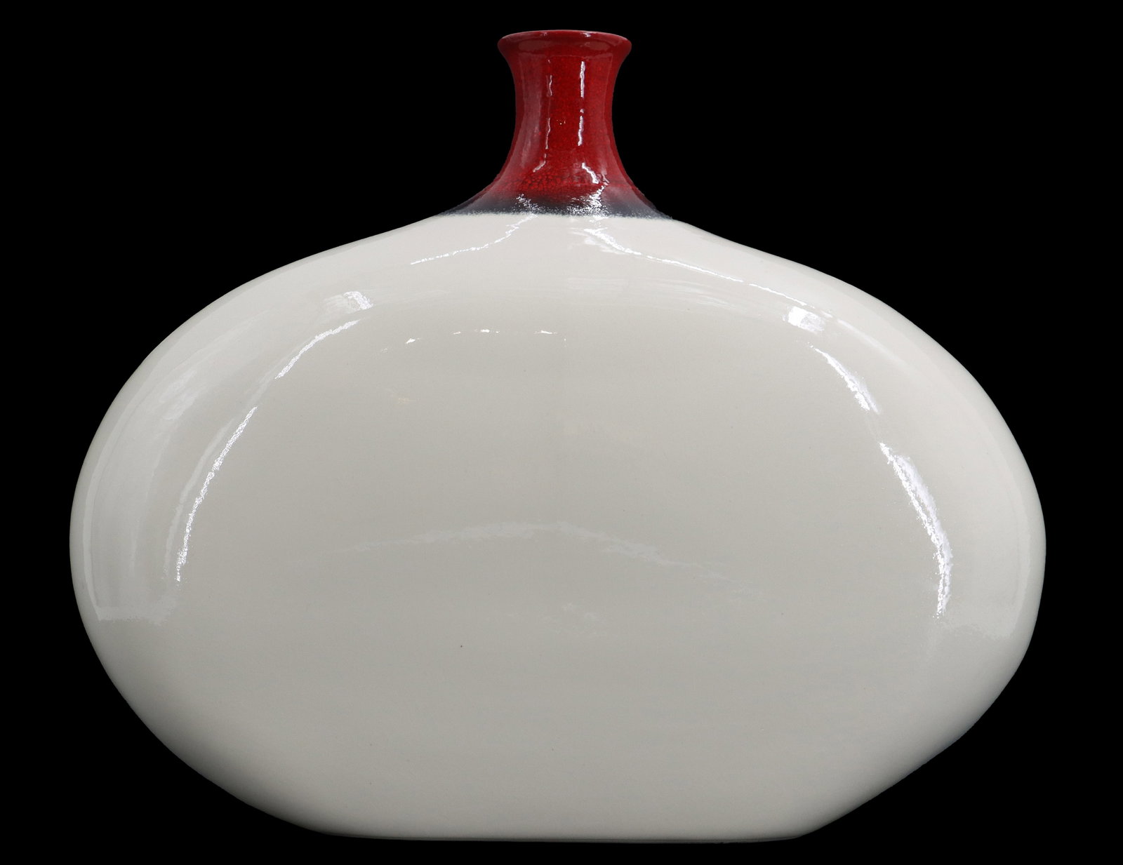 Compressed Oval Body Off White Ceramic Vase with Dark Red Neck: Compressed Oval Body Off White Ceramic Vase with Dark Red Neck. Off-white, oval-shaped ceramic vase features a smooth, glossy finish and a contrasting dark red, narrow neck. Size: 6 x 14 x 11 1/2