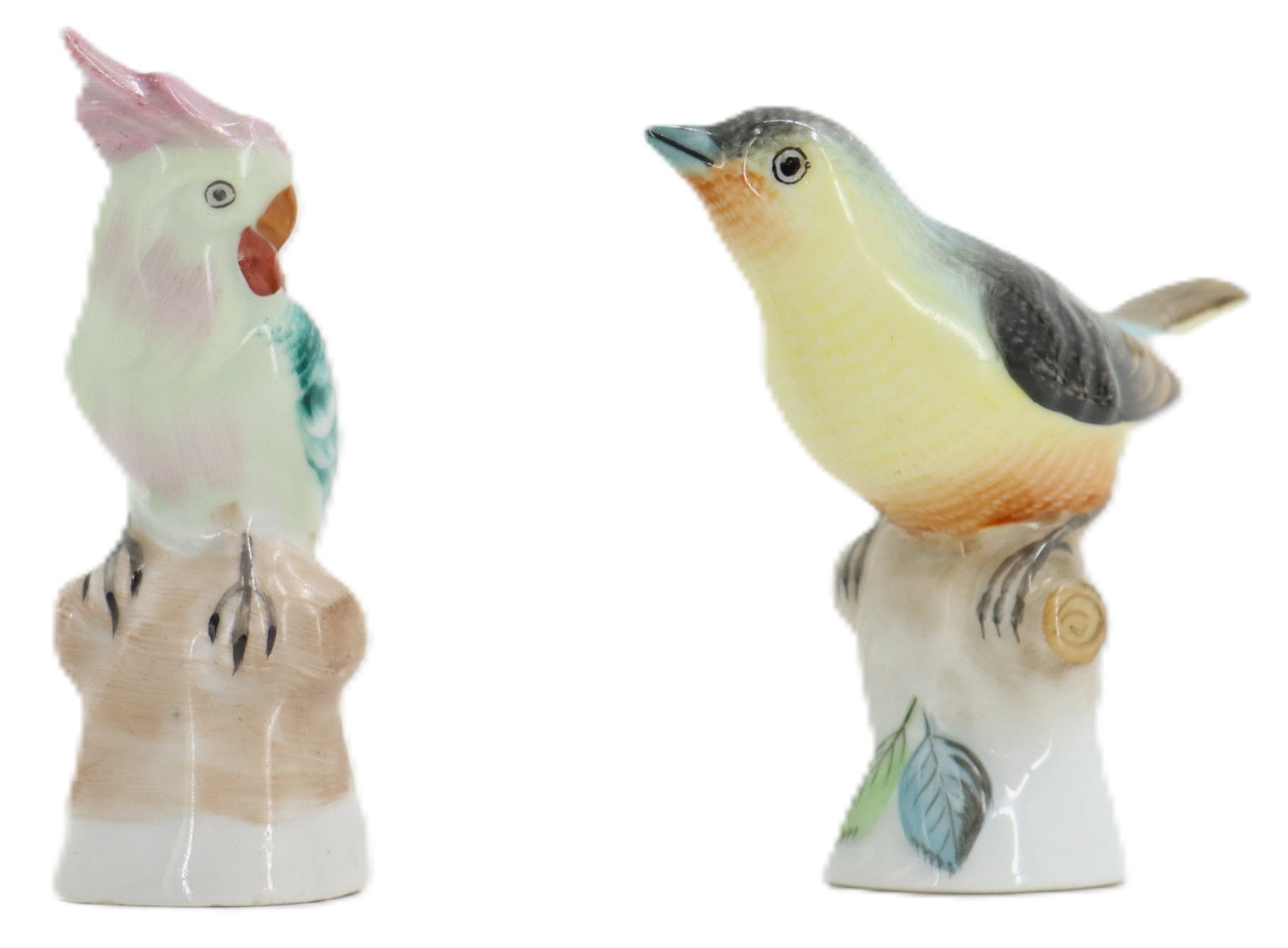 (2) Herend Hungary Porcelain Birds: (2) Herend Hungary Porcelain Birds. 2 small bird figurines, each perched on a piece of "wood". The one on the left is a cockatoo parrot. Each marked on the underside with different Herend Hu