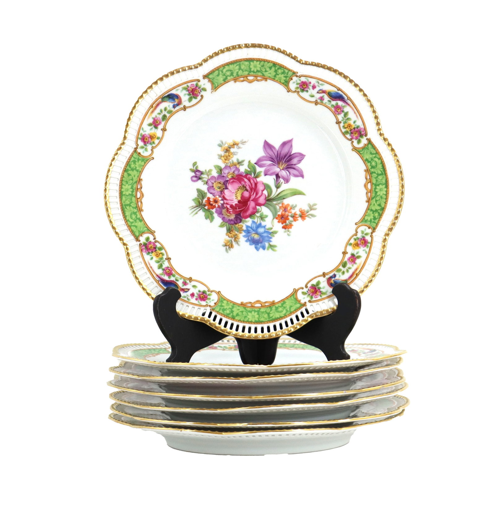 (7) German Schumann Bavaria Porcelain Plates: (7) German Schumann Bavaria Porcelain Plates. Set of scalloped fine porcelain dessert plates featuring a central floral bouquet, green patterned borders with gilded accents, and delicate pierced rims.