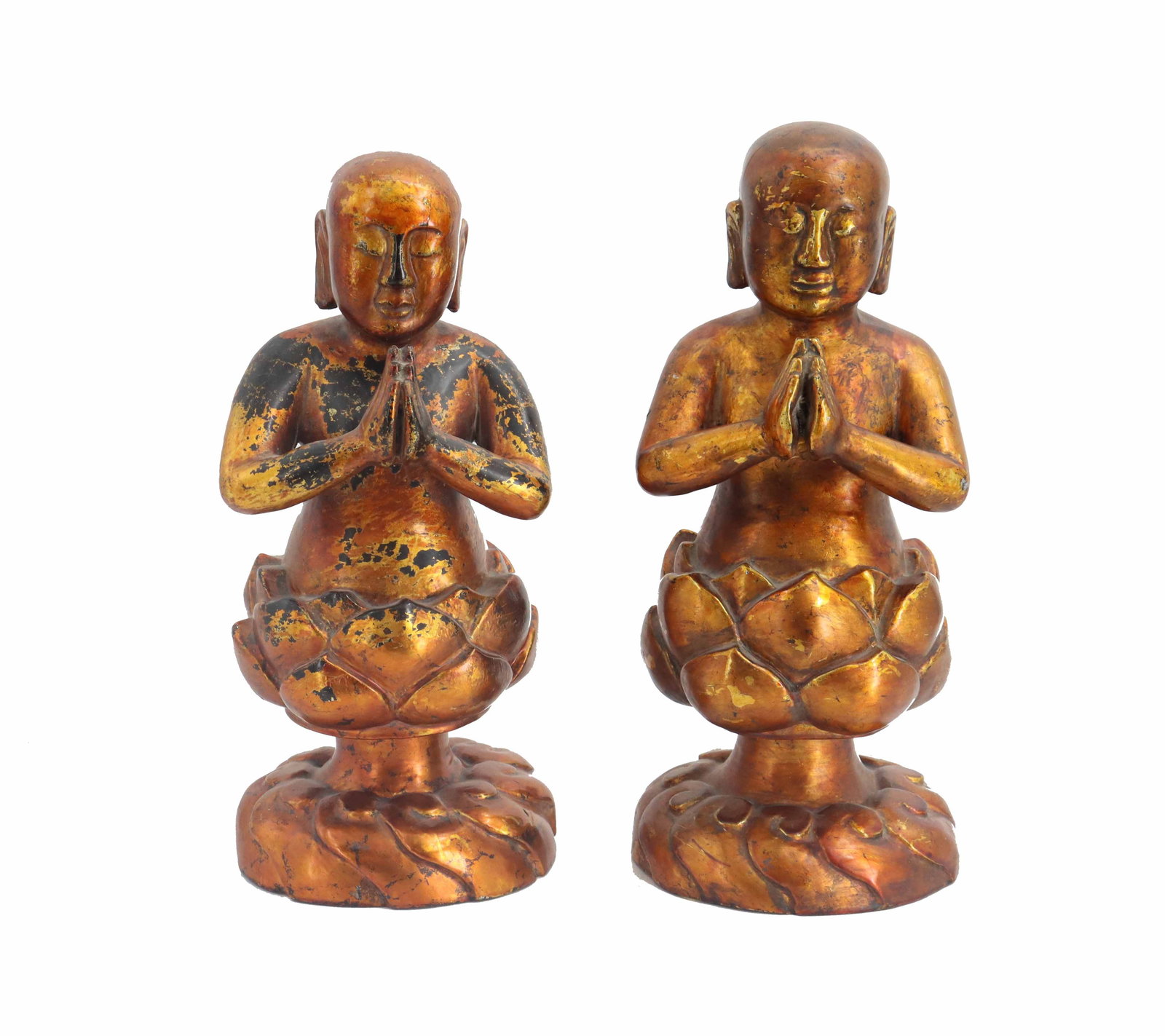 (2) Vintage Vietnamese Carved Gilt Wood Buddhist Monk Statues: (2) Vintage Vietnamese Carved Gilt Wood Buddhist Monk Statues. Nearly identical designs, depicting two bald monk with eyes closed while praying, with their upper torso coming out of lotus flowers