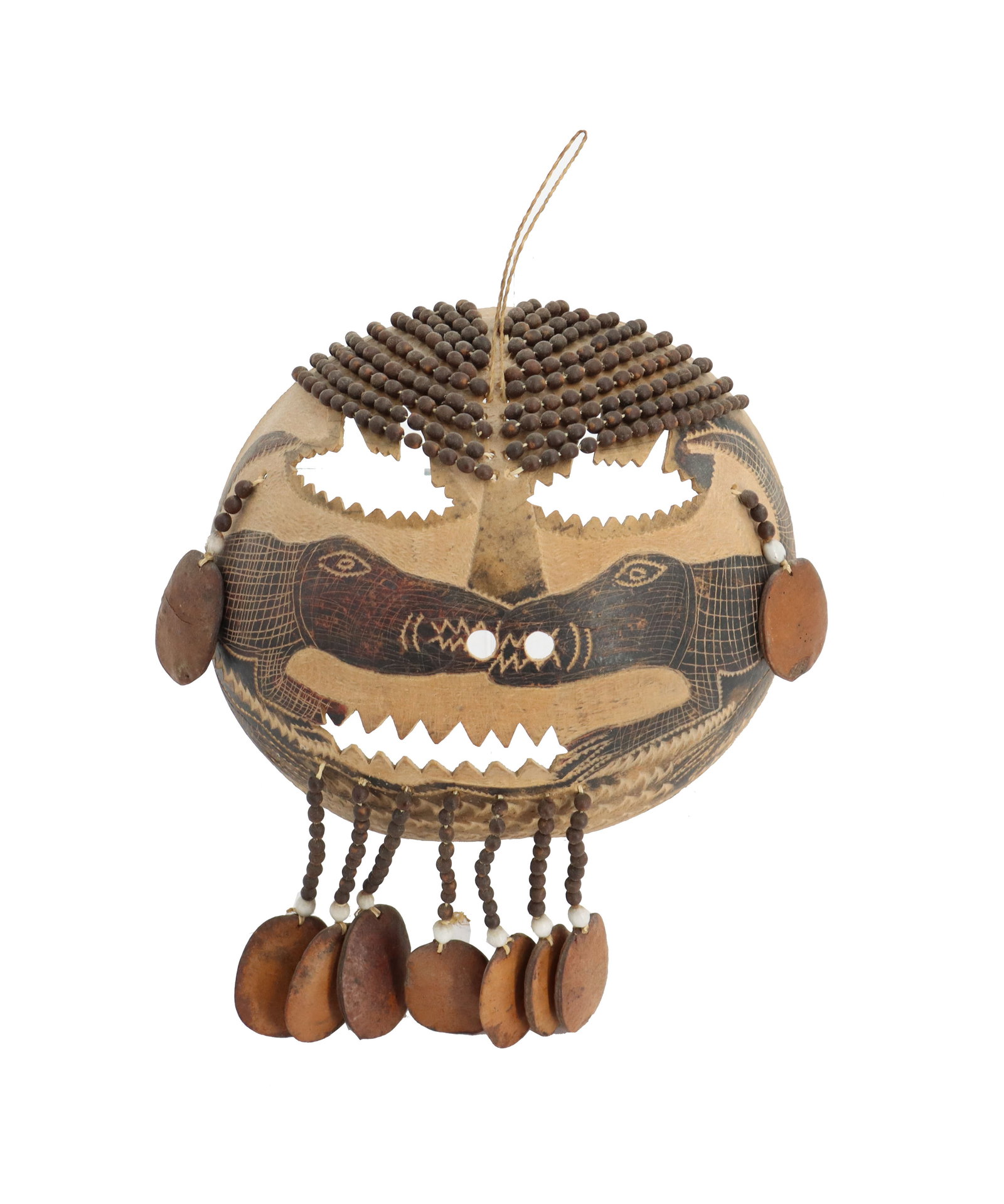 African Tribal Crocodile Motif Carved Wood and Seed Bead Decorations Mask: African Tribal Crocodile Motif Carved Wood and Seed Bead Decorations Mask. The piece is half of a gourd, hollowed out and chiseled to make the designs and the jagged edges of the eyes and mouth. The s