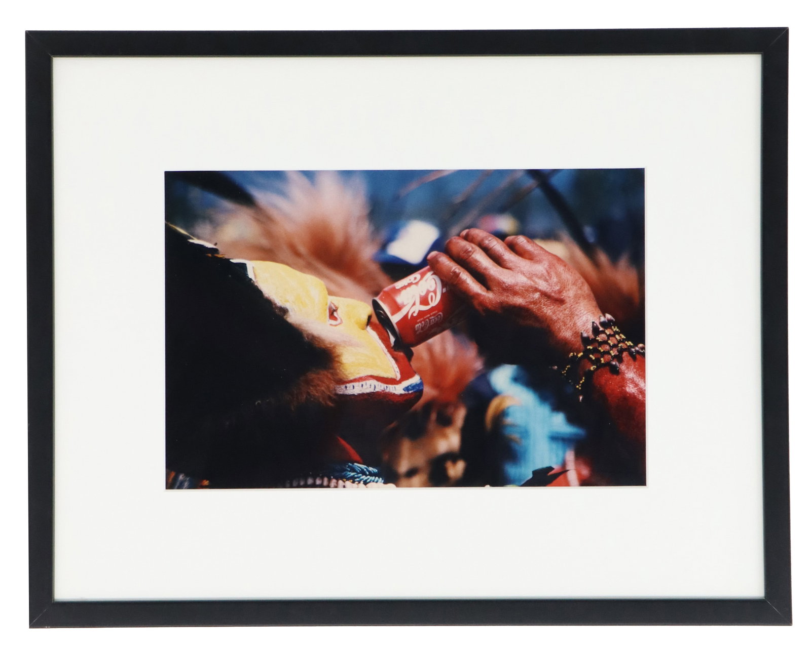 Framed Photo of African Man Drinking Coca-Cola: Framed Photo of African Man Drinking Coca-Cola. The man in the photo is from New Guinea. A striking color photograph depicting a figure in what appears to be traditional or ritualistic body paint