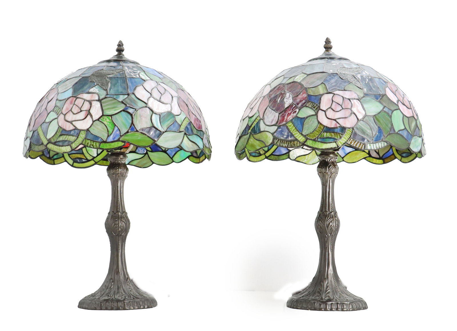 (2) Tiffany Style Stained Glass Floral Table Lamps: (2) Tiffany Style Stained Glass Floral Table Lamps. Pair of decorative Tiffany-style table lamps, each featuring a domed stained-glass shade with a pattern of white and pink roses among green leaves a