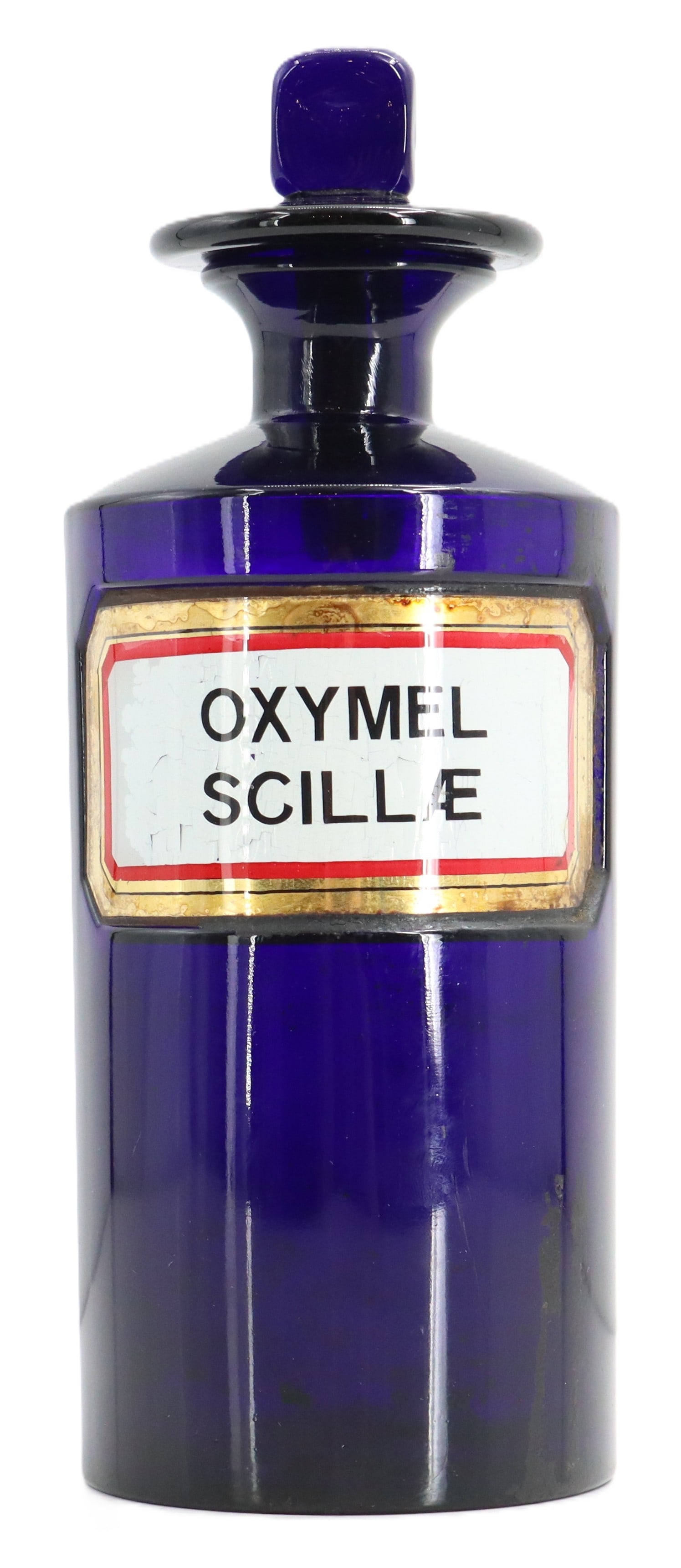 Antique Victorian Cobalt Glass Oxymel Scillae Apothecary Bottle: Antique Victorian Cobalt Glass Oxymel Scillae Apothecary Bottle. A striking, cobalt blue glass apothecary jar with a matching stopper and a white label framed in gold and red that reads "OXY