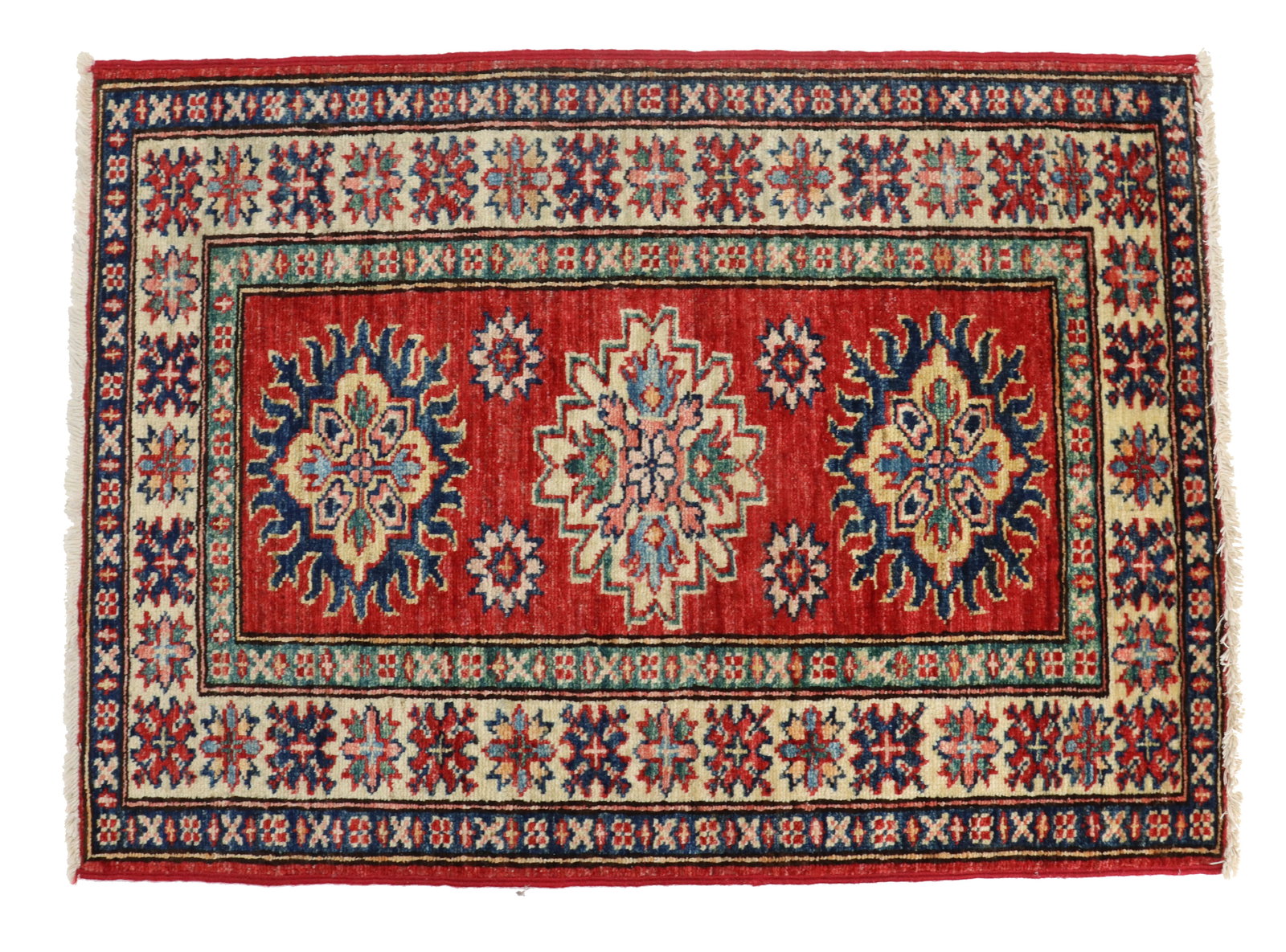 Small Kazak Wool Rug: Small Persian Kazak Wool Rug. Red dominates the edges and the center field, with vivid navy, tan, pink, and other tones forming floral patterns in the borders. Three similarly floral medallions take u
