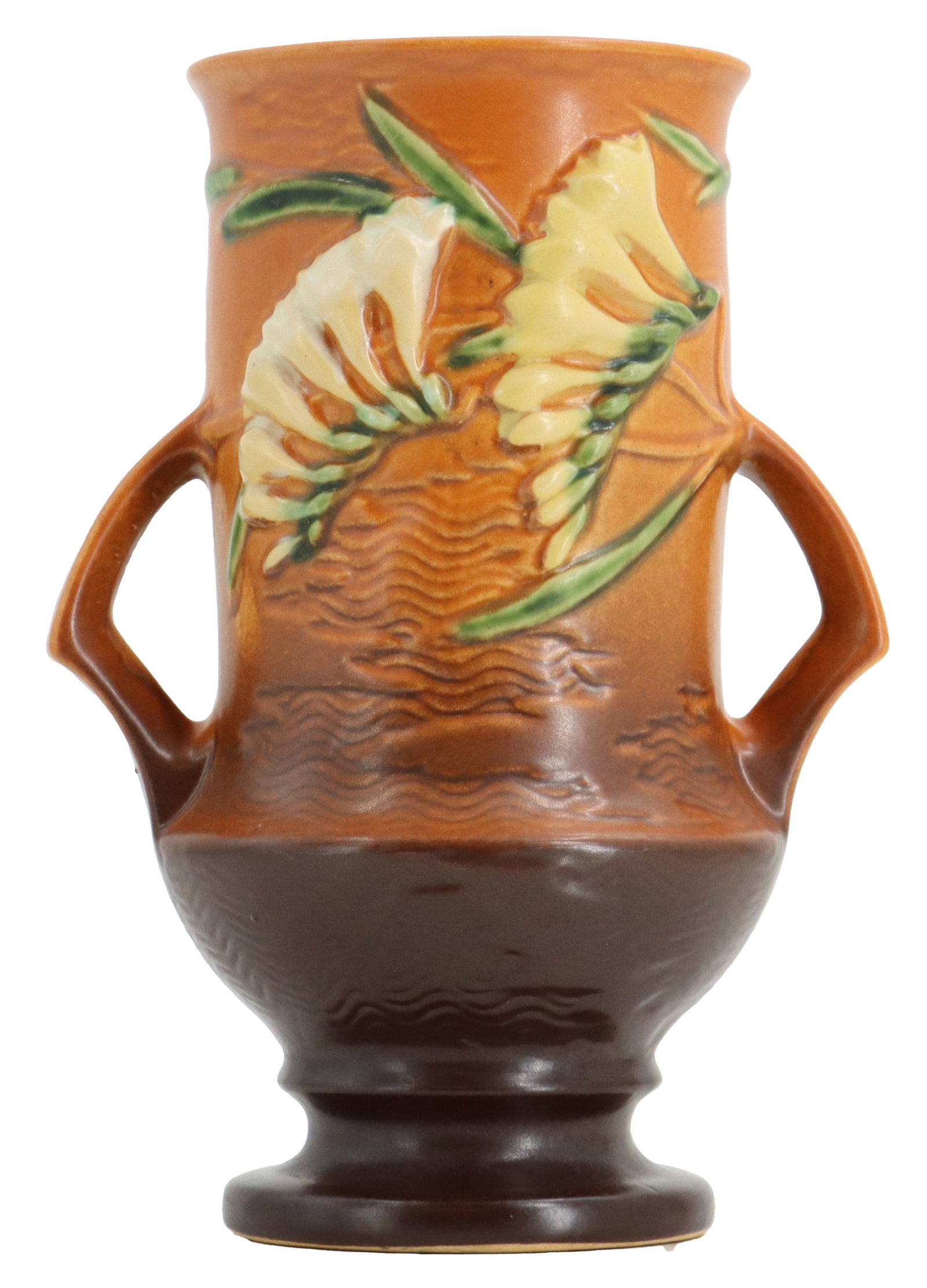 Roseville Pottery Freesia Vase: Roseville Pottery Freesia Vase. Vintage Roseville Clematis art pottery vase featuring a warm brown glaze, two low-set handles, and embossed yellow floral motifs. Signed on base.Size: 6 1/2 x 4