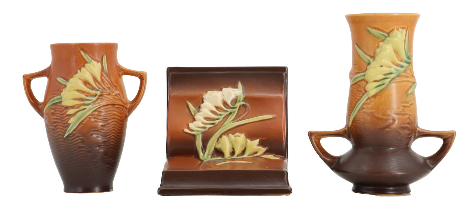 (2) Roseville Pottery Freesia Line and (1) Bookend: (2) Roseville Pottery Freesia Line and (1) Bookend. Includes two two-handled vases and a low rectangular piece, all featuring the vintage Roseville Freesia art pottery pattern with warm brown glazes