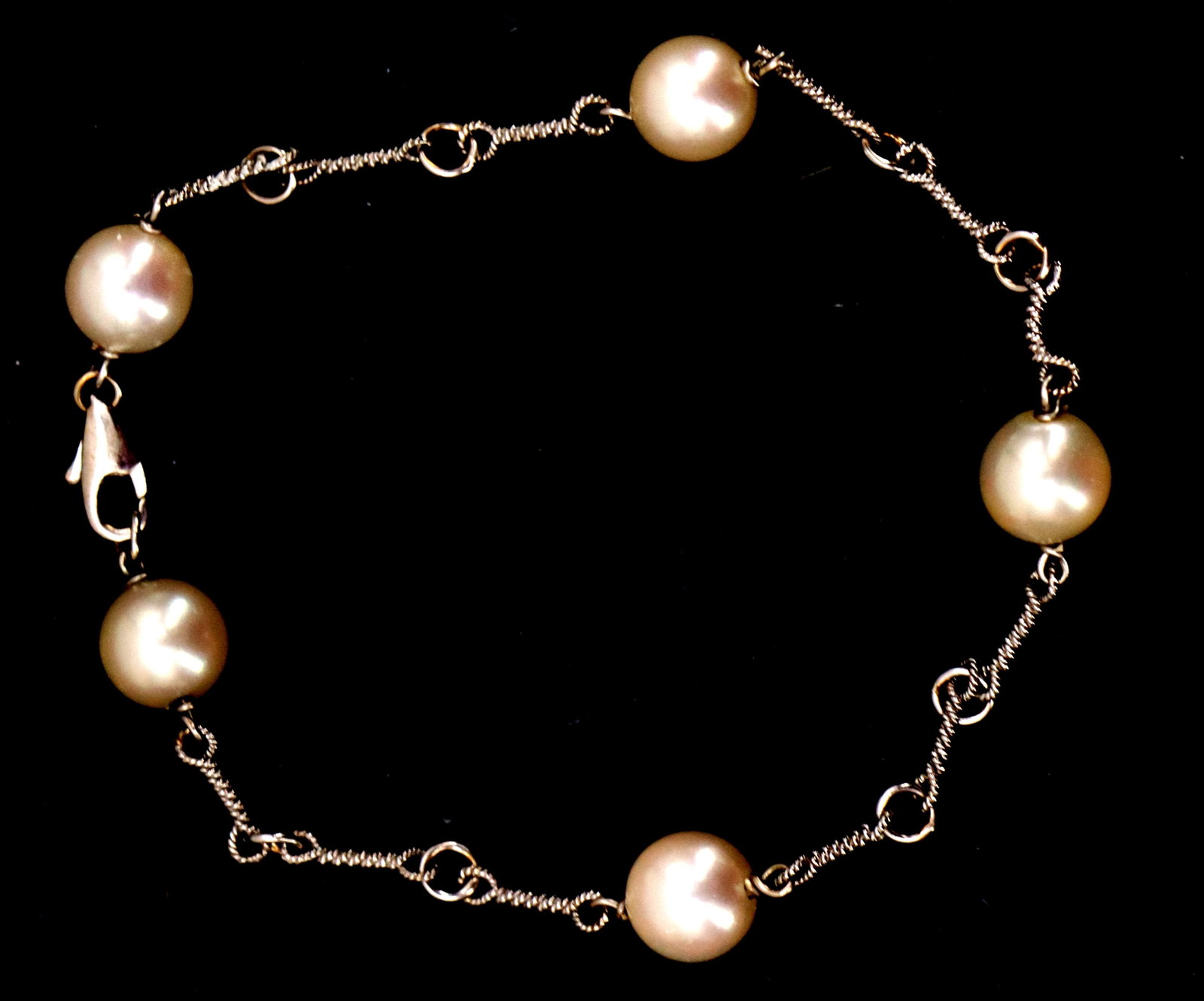 Marked 18k White Gold and Cultured Pearl Bracelet - Gross 4.7 g.: Marked 18k White Gold and Cultured Pearl Bracelet - Gross 4.7 g. 5 round polished pearls along the strand at equal distances. Marked "750" on the clasp. Size: (open) 7 in. long G