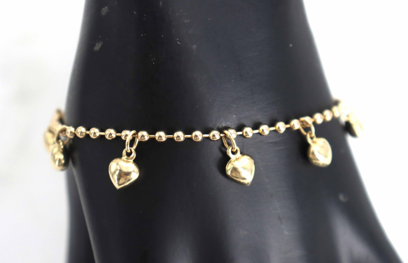 Tested 14k Yellow Gold Charm Bracelet - 5.8 g - AS IS: Tested 14k Yellow Gold Charm Bracelet - 5.8 g - AS IS. Ornate, circular silver-toned pendant featuring a meticulously detailed openwork design of symmetrical floral and scrolling filigree motifs.