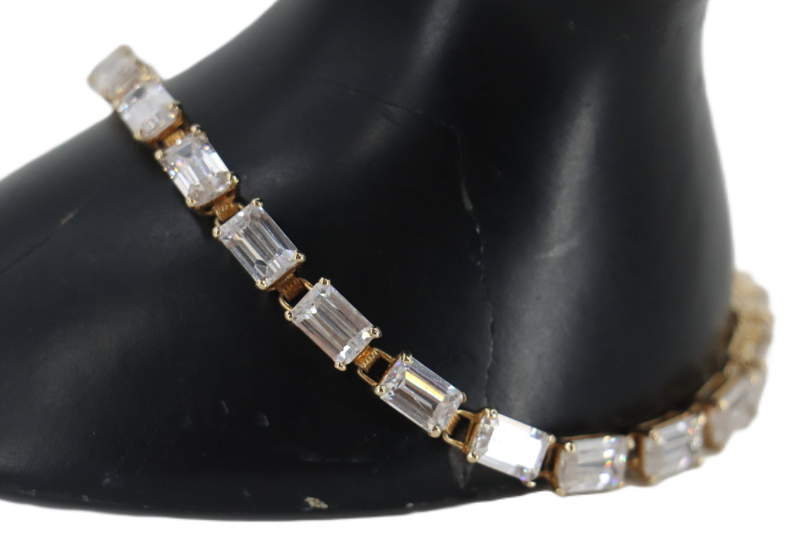 10k Gold and Natural Clear Stone Bracelet - Gross 8.2 g.: 10k Gold and Natural Clear Stone Bracelet. Marked on clasp. Rectangular cut stones set in 10k yellow gold. Condition: 1 stone missing. Length: 7 1/4 in. Gross Weight: 5.2 dwt. 8