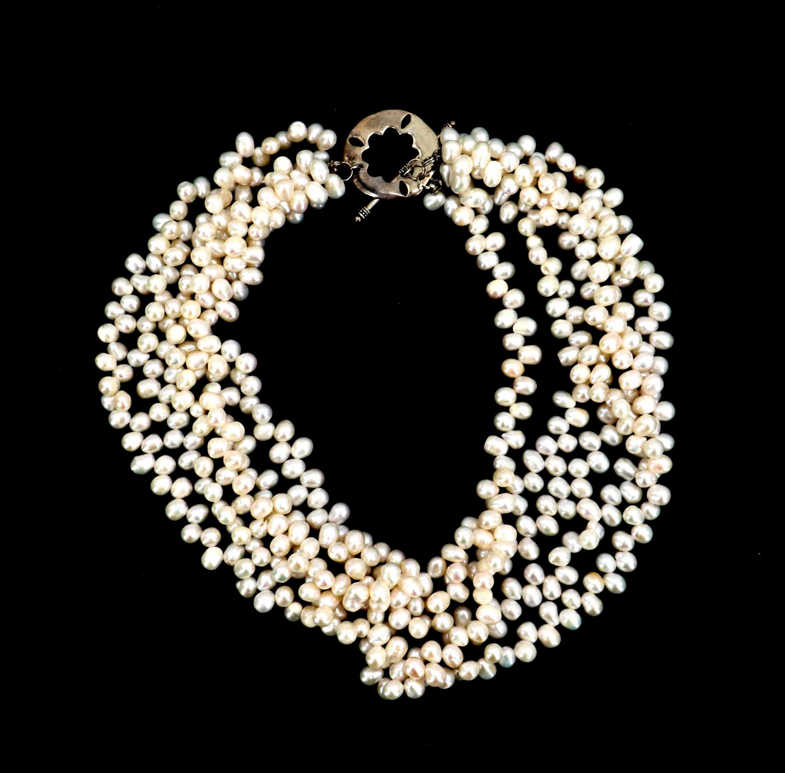 Five Strand Pearl Necklace with Silver Clasp: Five Strand Pearl Necklace with Silver Clasp. Features several rows of baroque freshwater pearls with a luminous, creamy luster and irregular shapes. Length: 18 in.
