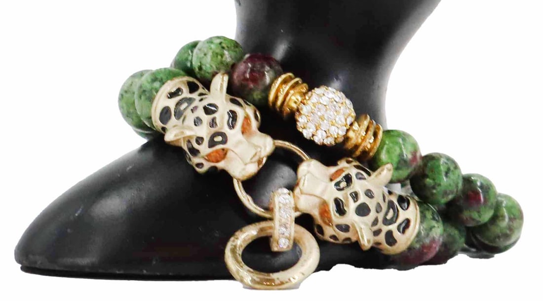 (2) Ruby Zoisite Bracelets: (2) Ruby Zoisite Bracelets. One has a metal and diamond clasp, and the other has a clasp made up of two polychrome metal leopard heads chomping on rings with diamonds on them. Largest Size: 3 1/