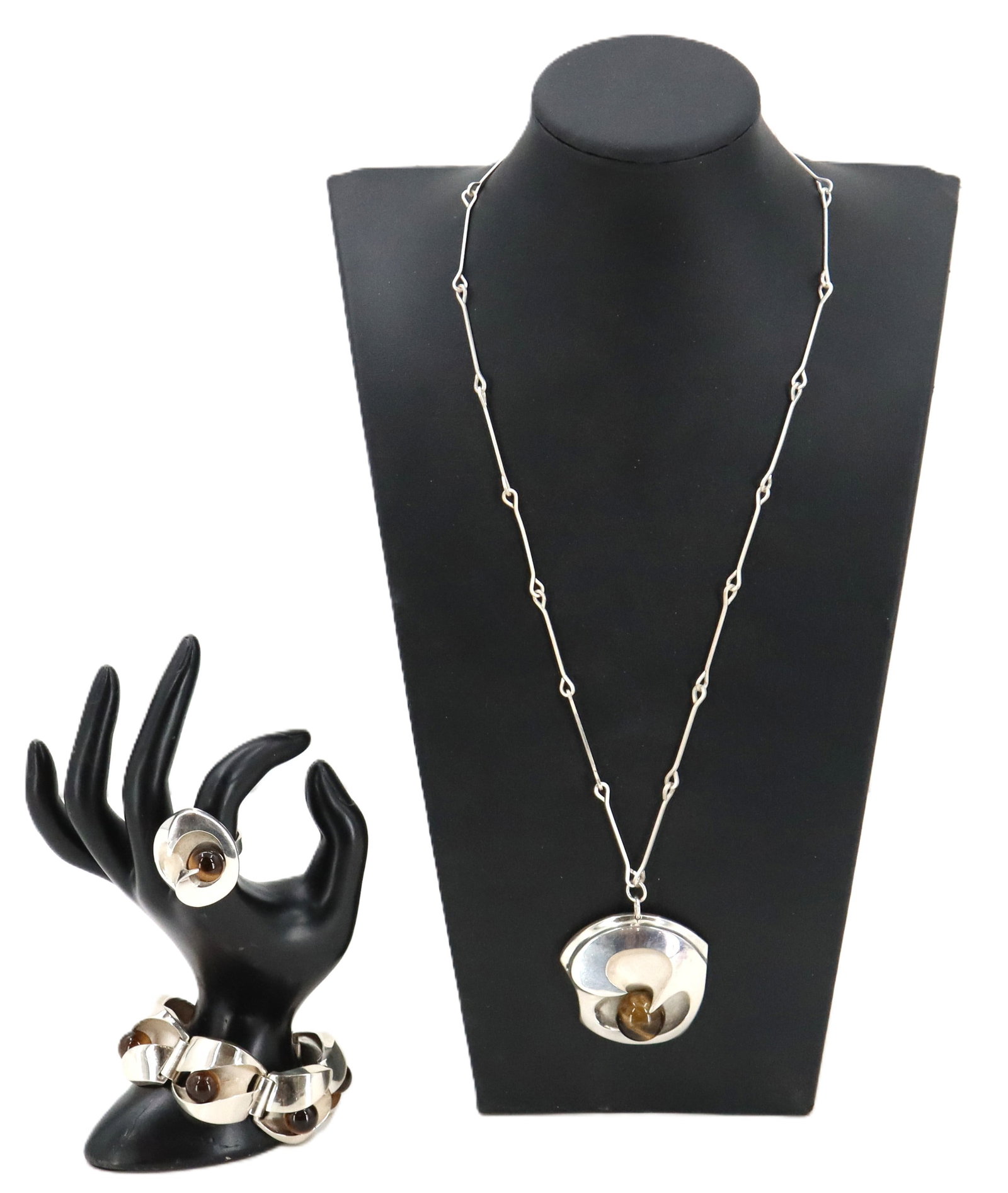 Sterling Silver and Tigers Eye Jewelry Set - Gross 4.275 ozt.: Sterling Silver and Tigers Eye Jewelry Set. Marked on inside of ring and near clasp on bracelet. Each piece showcases an organic, sculptural "wave" design centered by a polished