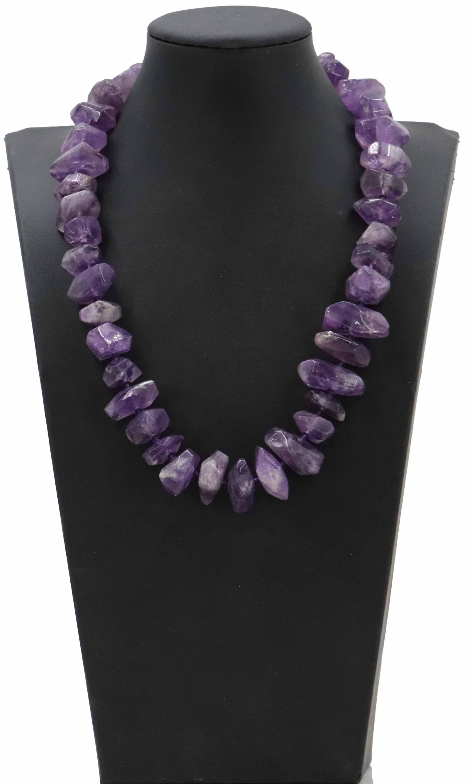 Amethyst Necklace with Sterling Silver Clasp: Amethyst Necklace with Sterling Silver Clasp. Marked on clasp. Features chunks tumbled amethyst nuggets that showcase a range of deep purple and lavender hues with natural inclusions. Strung in a sing