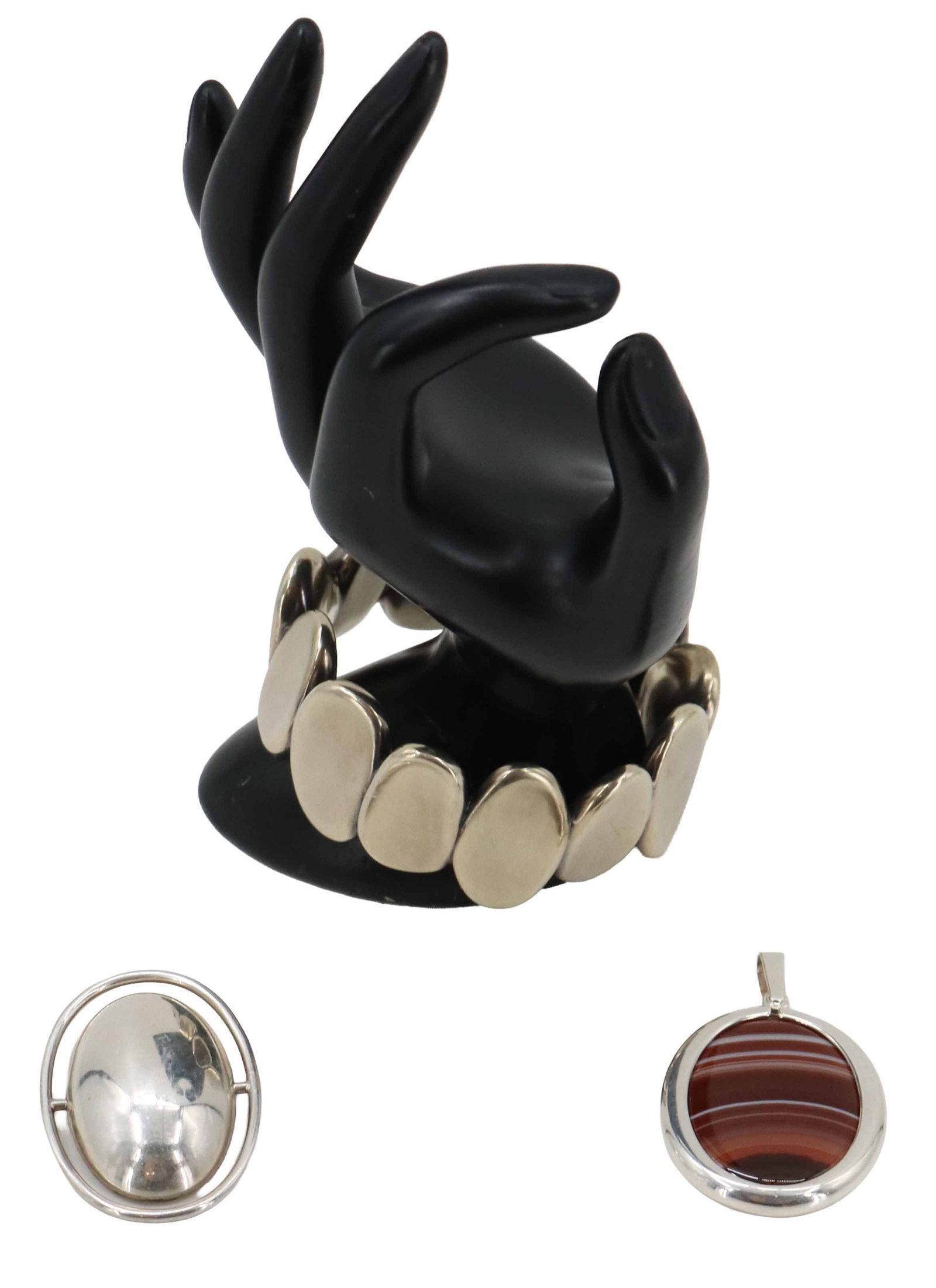 Sterling Silver and Stone Jewelry Set: Sterling Silver and Stone Jewelry Set. Features a bracelet consisting of silver ovals, marked on inside. One pendant with an oval cut stone in center, marked on bail. One pendant/brooch oval shaped si