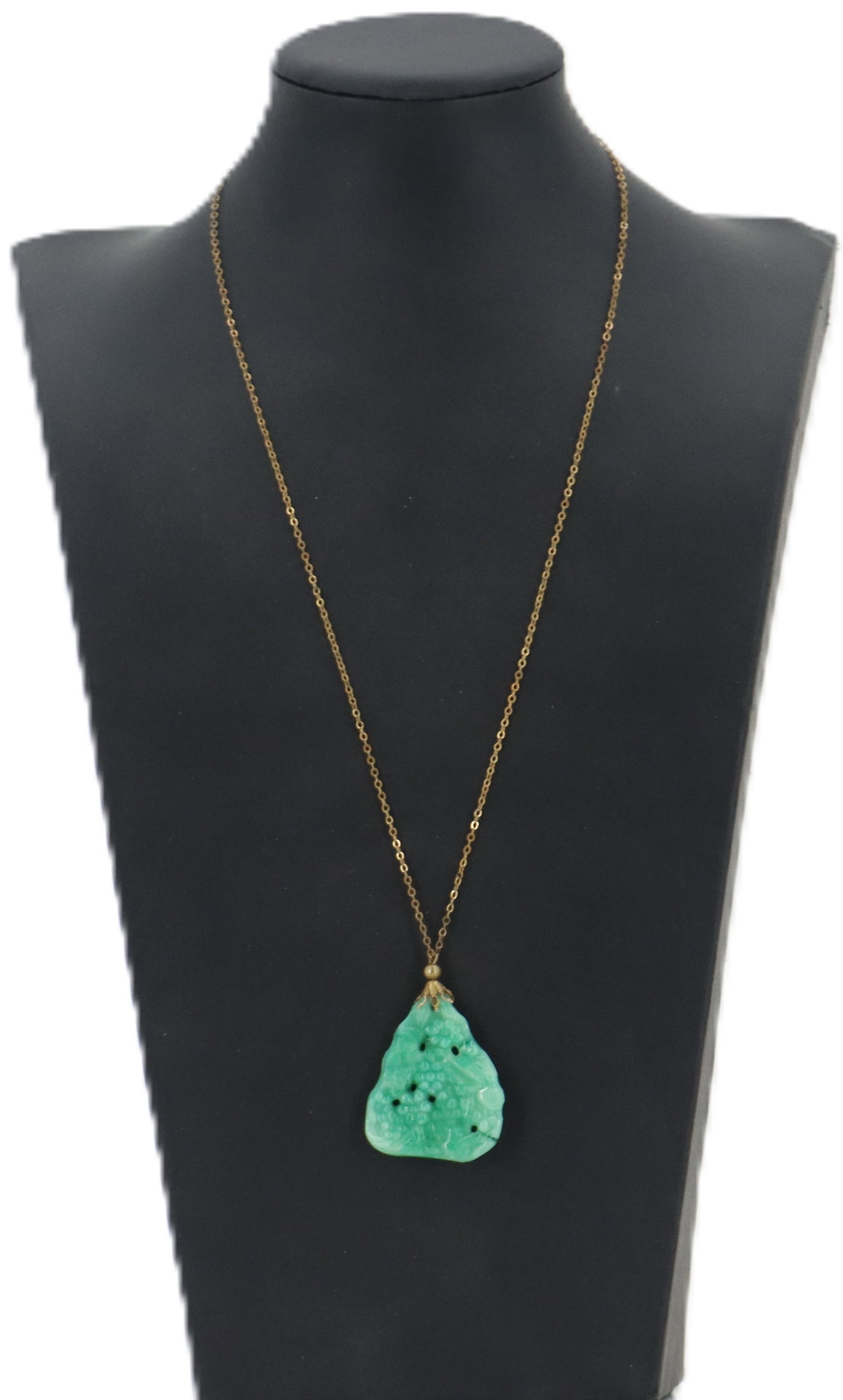 Carved Jadeite Pendant on Gold Filled Chain Necklace: Carved Jadeite Pendant on Gold Filled Chain Necklace. A triangle shaped piece carved into berries and leaves. Length: 21 in. Pendant Size: 1 3/4 x 1 3/8 in. 