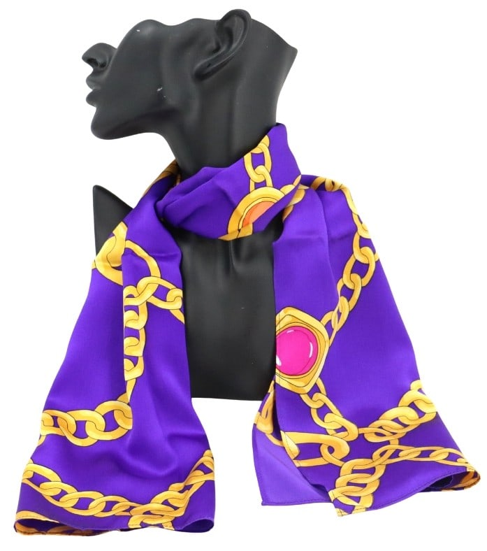St. John Purple and Gold Silk Scarf with Machine-Stitched Edge: St. John Purple and Gold Silk Scarf with Machine-Stitched Edge. Bright purple silk scarf featuring a bold graphic print of oversized golden chains and large pink gemstone-like medallions. Size: 41 x 1