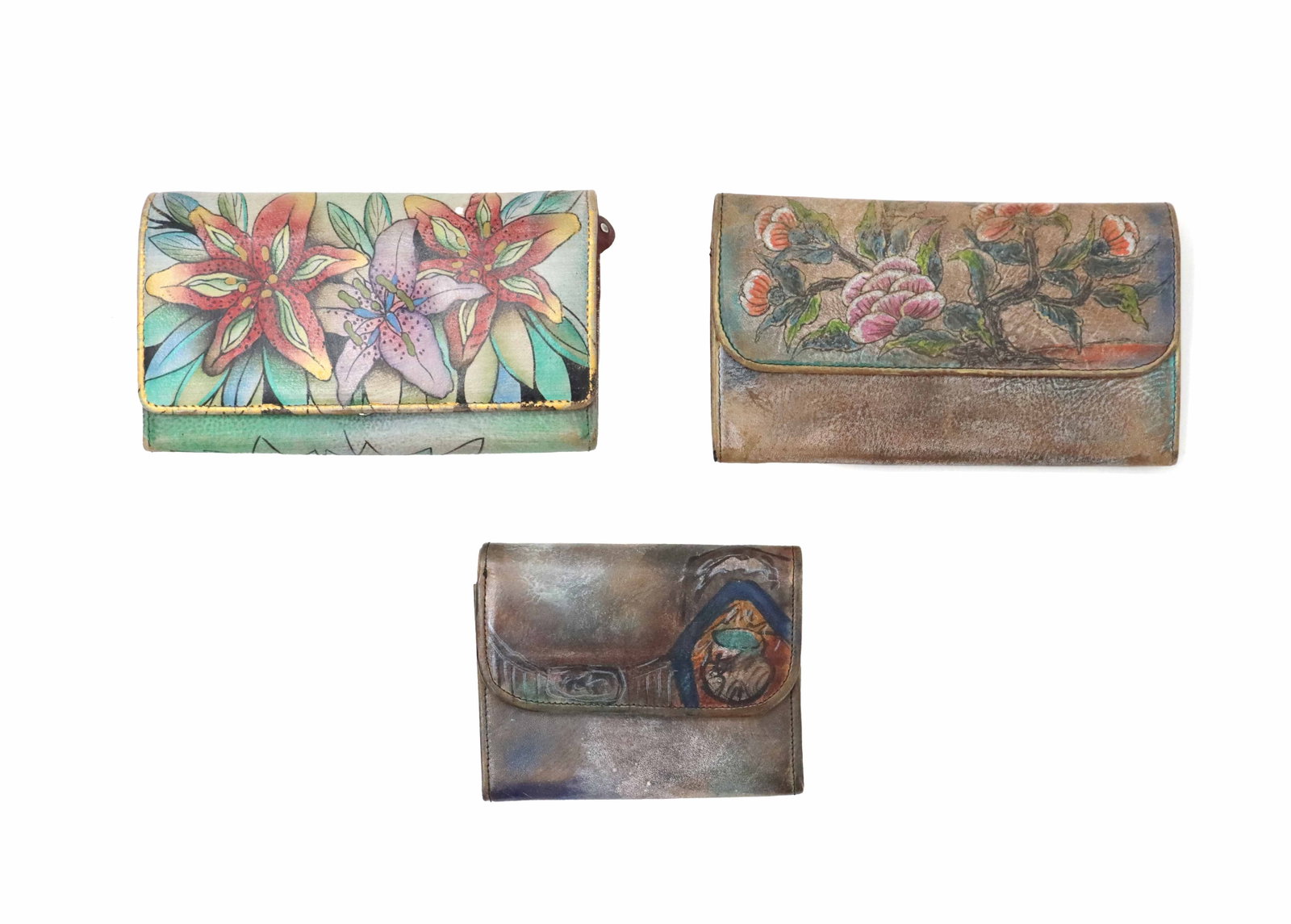 (2) Jane Yoo and (1) Anuschka Hand-Painted Leather Wallets: (2) Jane Yoo and (1) Anuschka Hand-Painted Leather Wallets. All marked. Size: 7 1/2 x 4 1/2 x 1 1/2 in. Jane Yoo is a Korean-born artist, presently living in the United States, who has bee