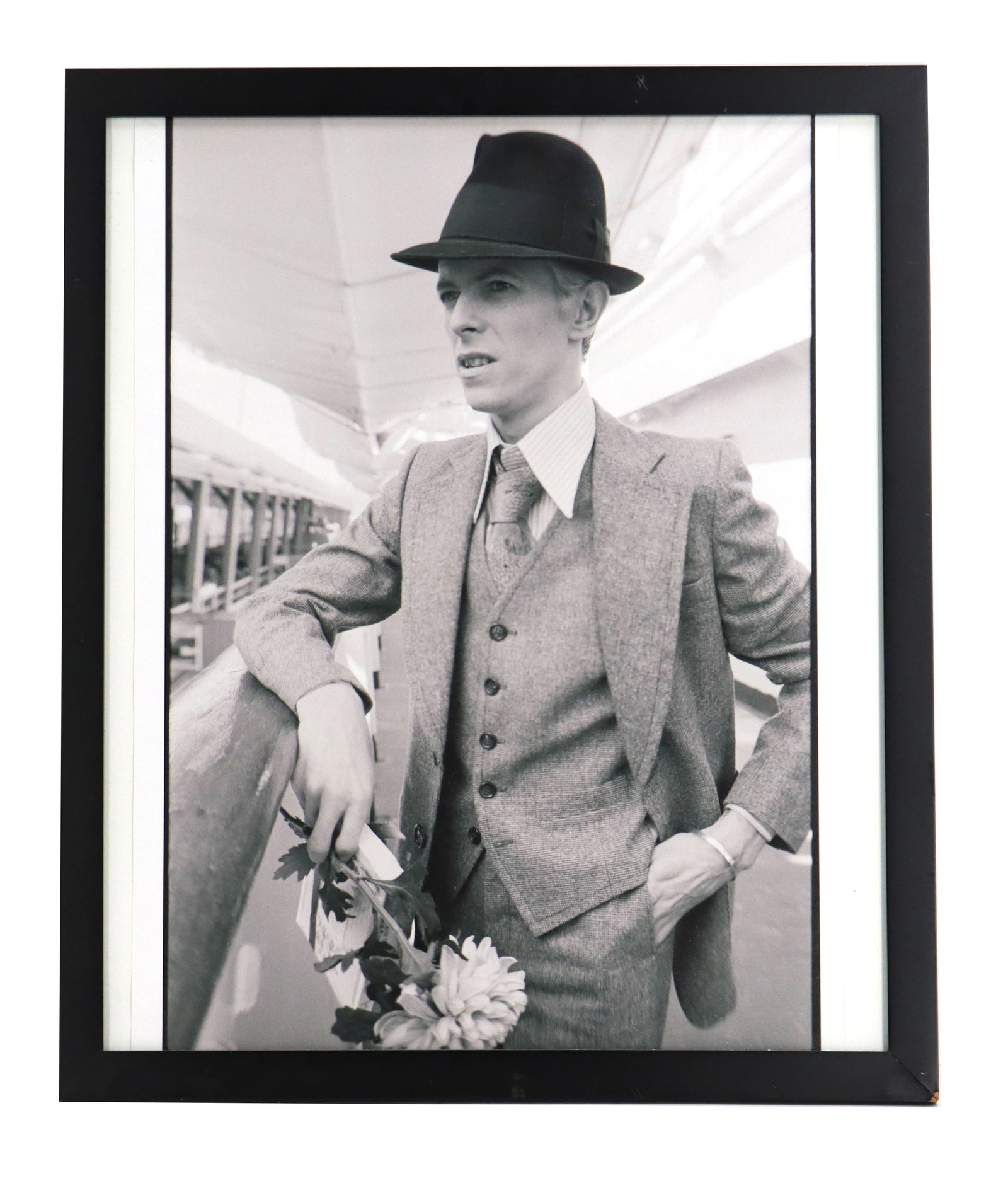 Andrew Kent (Born 1950) American, Black and White Photograph Print of David Bowie: Andrew Kent (Born 1950) American, Black and White Photograph Print of David Bowie. Black-and-white photograph of David Bowie, captured in a dapper three-piece suit and fedora while leaning against a r