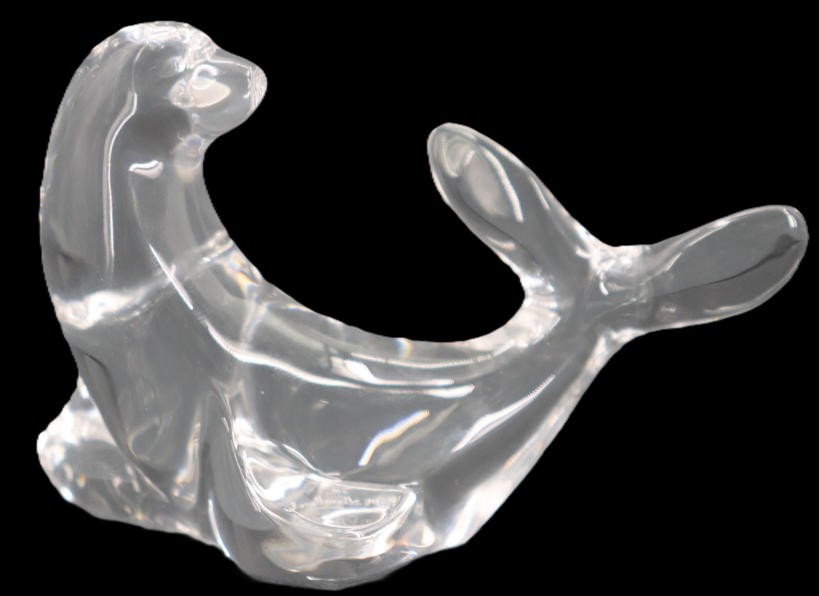 Belgian Val Saint Lambert Crystal Seal Sculpture: Belgian Val Saint Lambert Crystal Seal Sculpture. The playful animal is turned belly-up, raising his tail and head and resting on his flippers. Signed on underside. Size: 1 1/2 x 2 1/2 x 4 