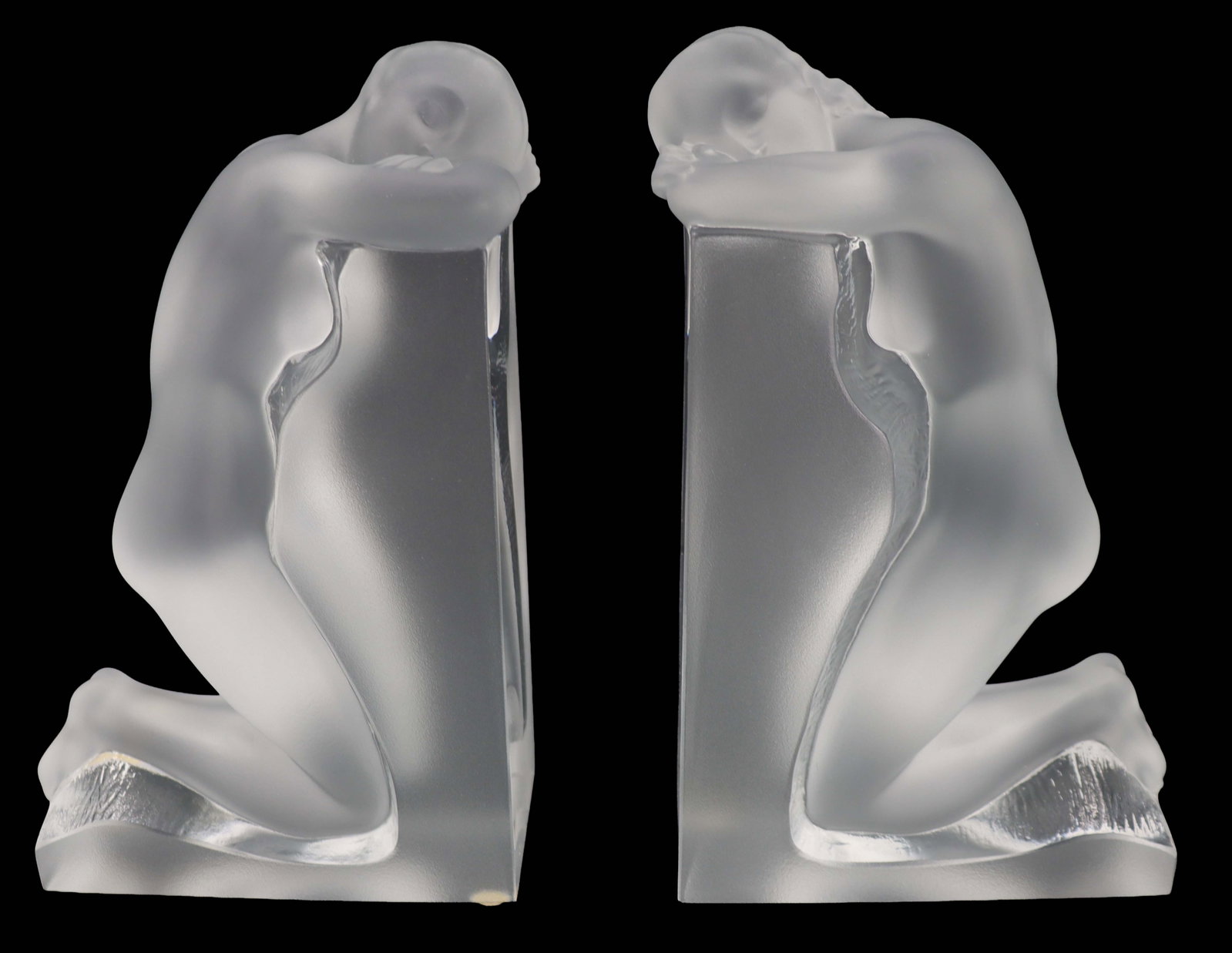 Pair of Lalique Frosted Crystal Nude Bookends in Original Box: Pair of Lalique Frosted Crystal Nude Bookends in Original Box. The two nude females mirror each other, leaning against the L-shape with their heads resting on their arms. Both signed on the back 