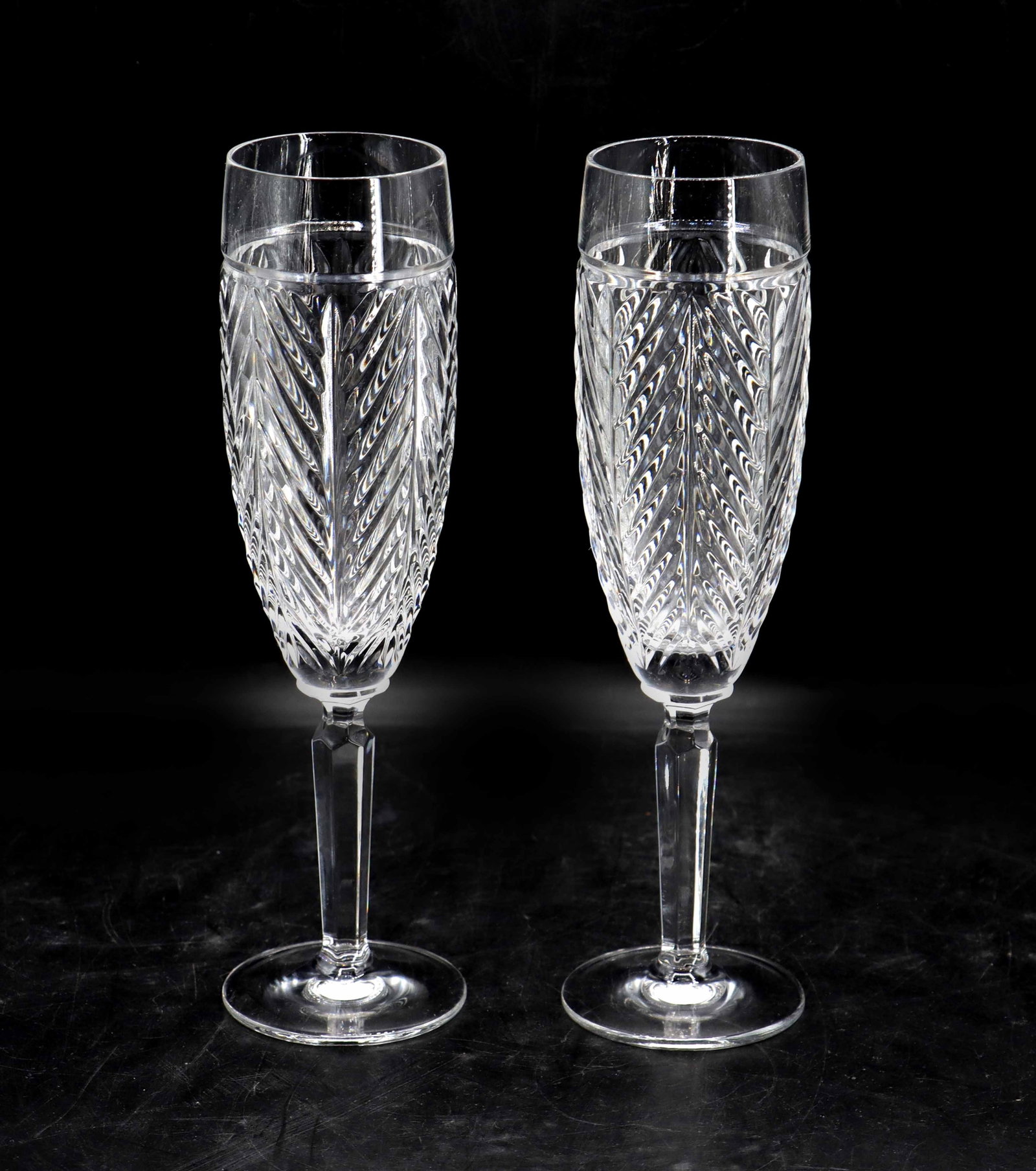 (2) Ralph Lauren Herringbone Cut Crystal Champagne Flutes: (2) Ralph Lauren Herringbone Cut Crystal Champagne Flutes. Stamped on the undersides. Size: 2 1/2 x 2 1/2 x 9 in. Ralph Lauren (born Ralph Lifshitz in 1939) is an American fashion designer