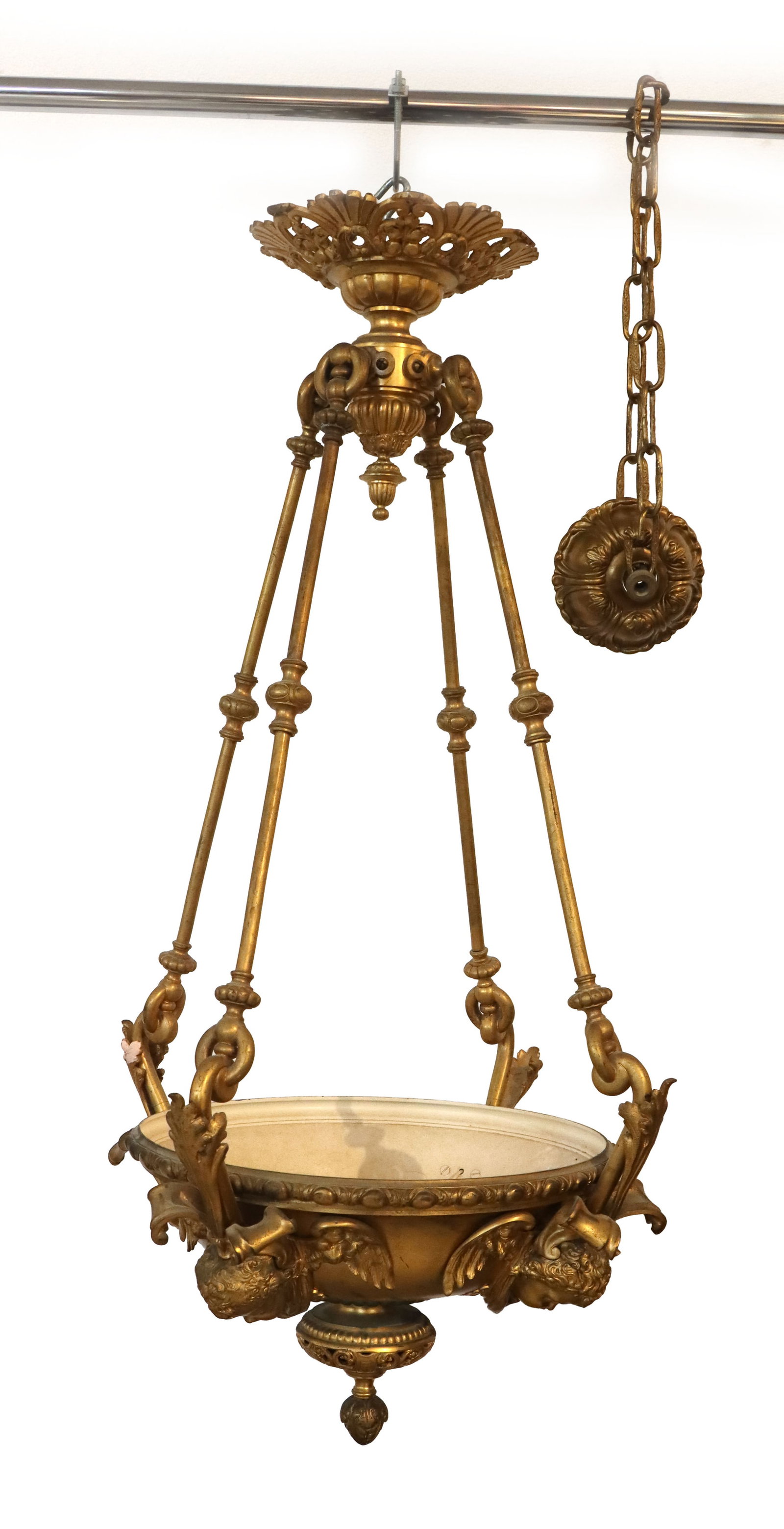 AS IS - French Neo-Rococo Brass Hanging Light with Cherub Faces: Doesn't hang perfectly straight, but pictures accurately depict design. French Neo-Rococo Brass Hanging Light with Cherub Faces. The opulent piece has a descending bulbous tassie that has a