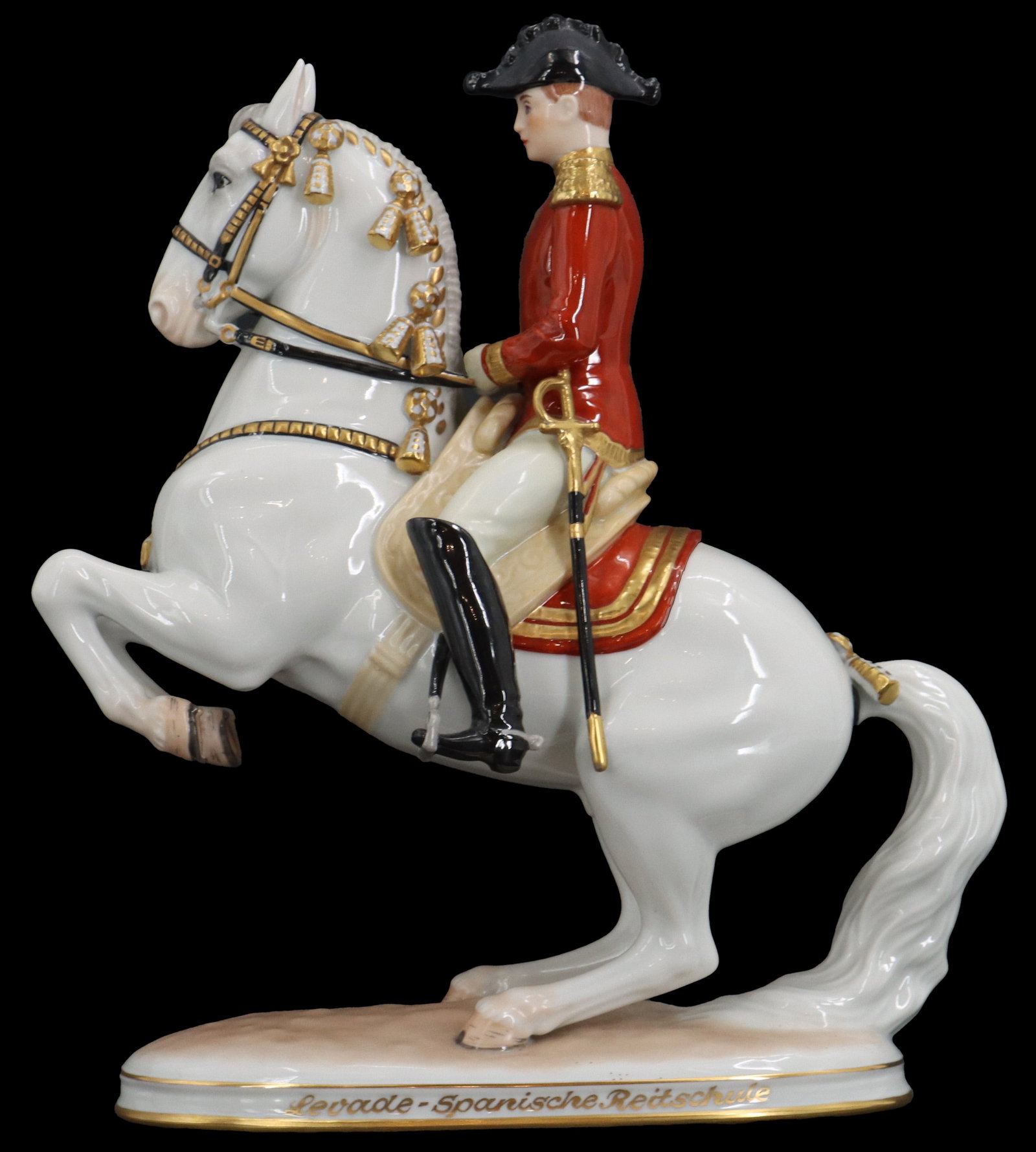 Austrian Augarten Porcelain Equestrian Figurine: Austrian Augarten Porcelain Equestrian Figurine. Classic Augarten Wien porcelain figurine depicting a Lipizzaner stallion from the Spanish Riding School performing a levade, featuring a rider in tradi