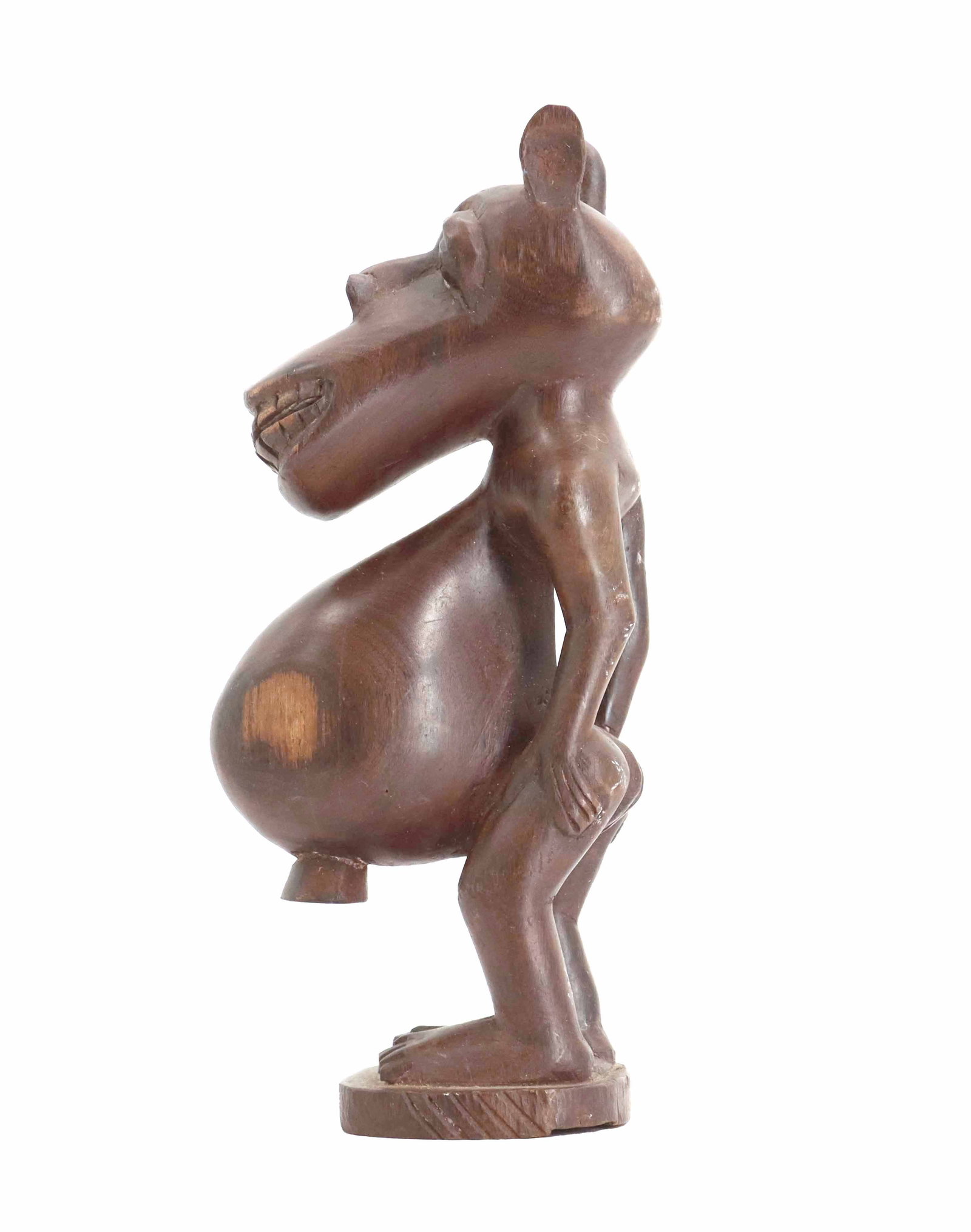 African Tribal Carved Wood Zoomorphic Fetish Statue: African Tribal Carved Wood Zoomorphic Fetish Statue. The head of a horse-like creature with elongated snout sits atop a gravely distended belly, with bent legs supporting the awkward form on a wooden 