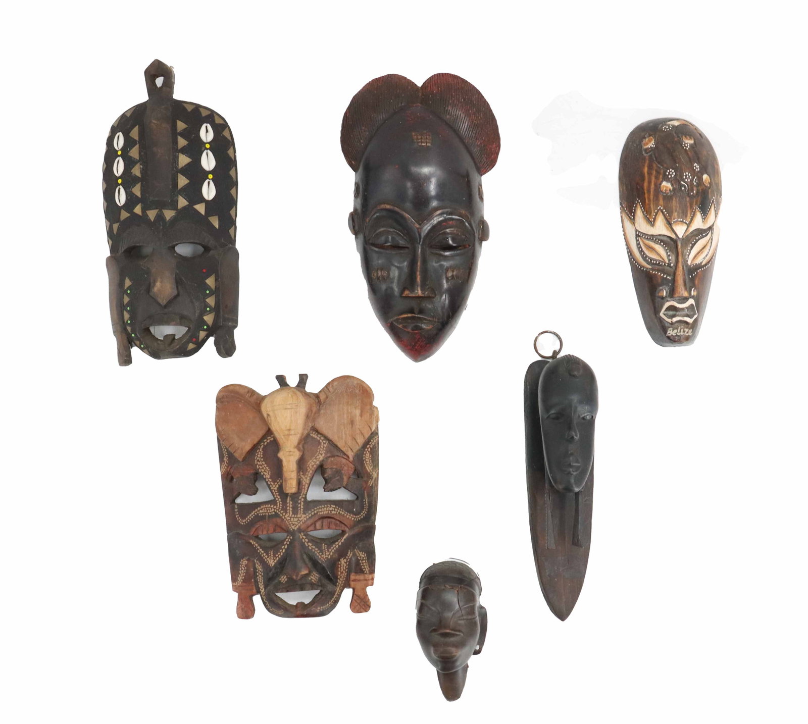 (6) Carved Wooden Tribal Masks as Wall Art from Africa and Central America: (6) Carved Wooden Tribal Masks as Wall Art from Africa and Central America. Each is a different style, including one from the Kuba tribe, one from the Makonde people, and one clearly marked "Beli