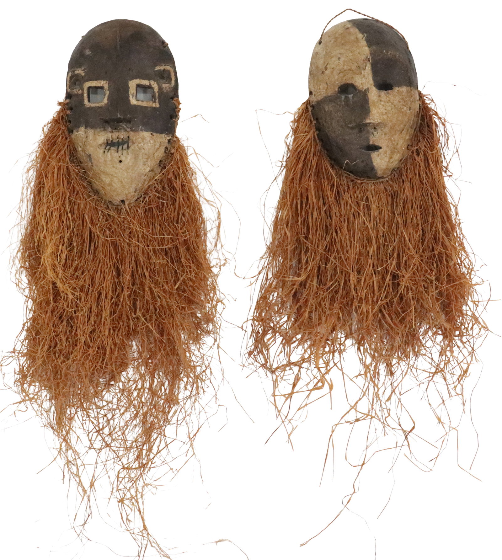 (2) African Carved Wood and Rafia Initiation Masks: (2) African Carved Wood and Rafia Initiation Masks. Pair of African initiation masks, likely of Salampasu or Yaka origin, featuring molded faces with contrasting dark and light pigments and long, dens