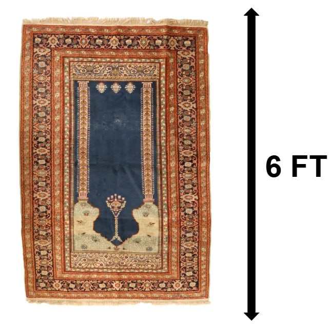 Antique Turkish Ghiordes Wool Prayer Rug: Antique Turkish Ghiordes Wool Prayer Rug. Classic form, with tan and rust tones in the floral borders and a rich deep blue tone dominating the field beneath the mihrab. The large size of this rug