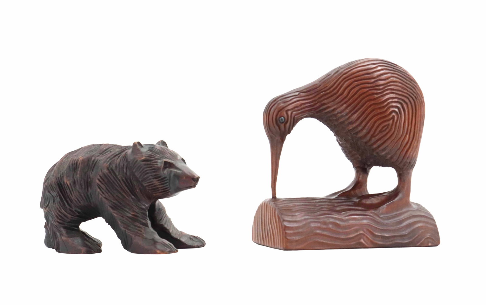(2) New Zealand Woodmasters Ltd. Bear and Kiwi Bird Wood Carvings: (2) New Zealand Woodmasters Ltd. Bear and Kiwi Bird Wood Carvings. Unmarked, though the designs appear as theirs in online searches. Both are grooved heavily in their trademark style, and the kiwi has