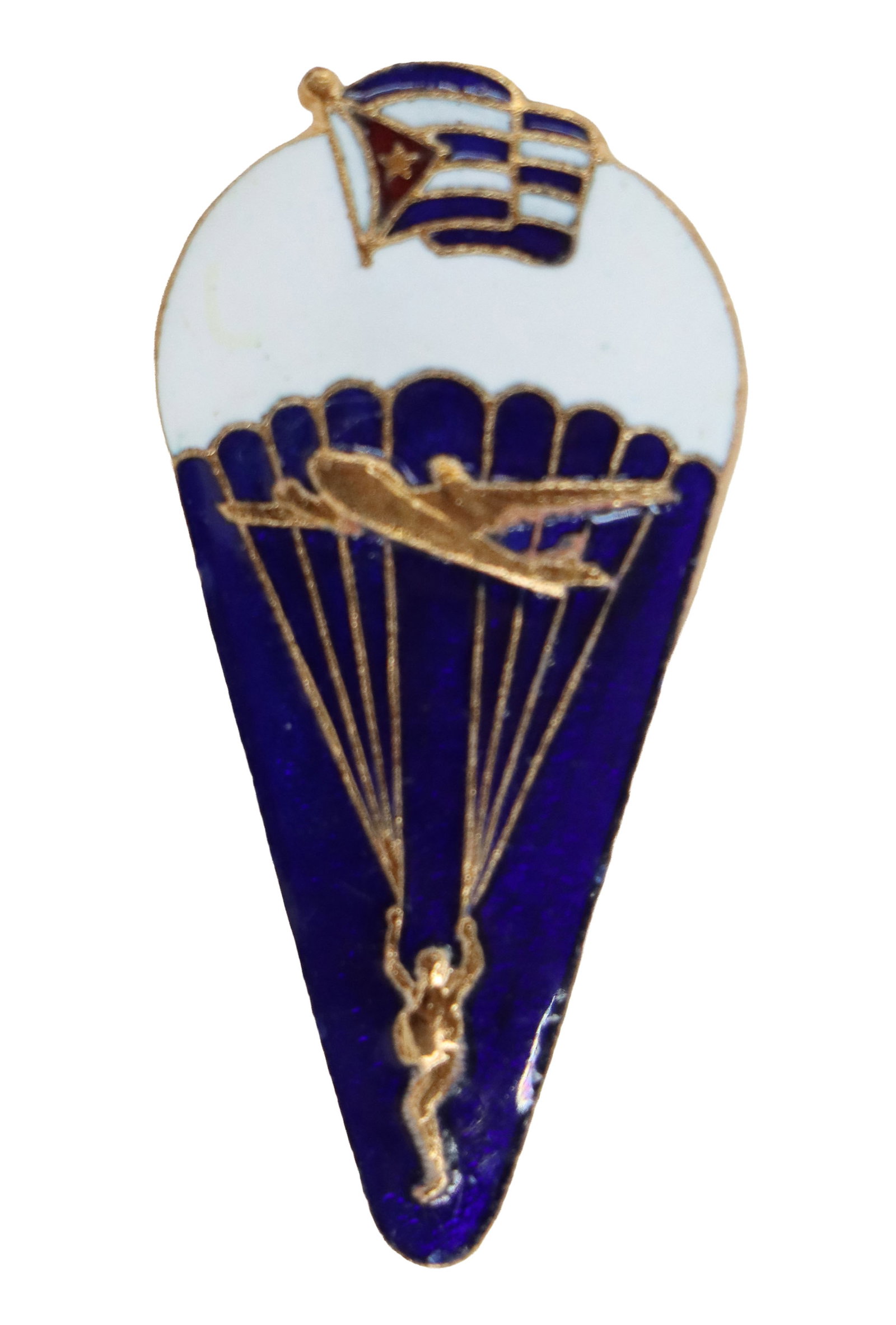 Vintage Cuban Airborne Troops Jump Badge: Vintage Cuban Airborne Troops Jump Badge. Tear-shaped insignia featuring a stylized parachute canopy topped by a Cuban flag, with an aircraft and a descending paratrooper set against a deep blue