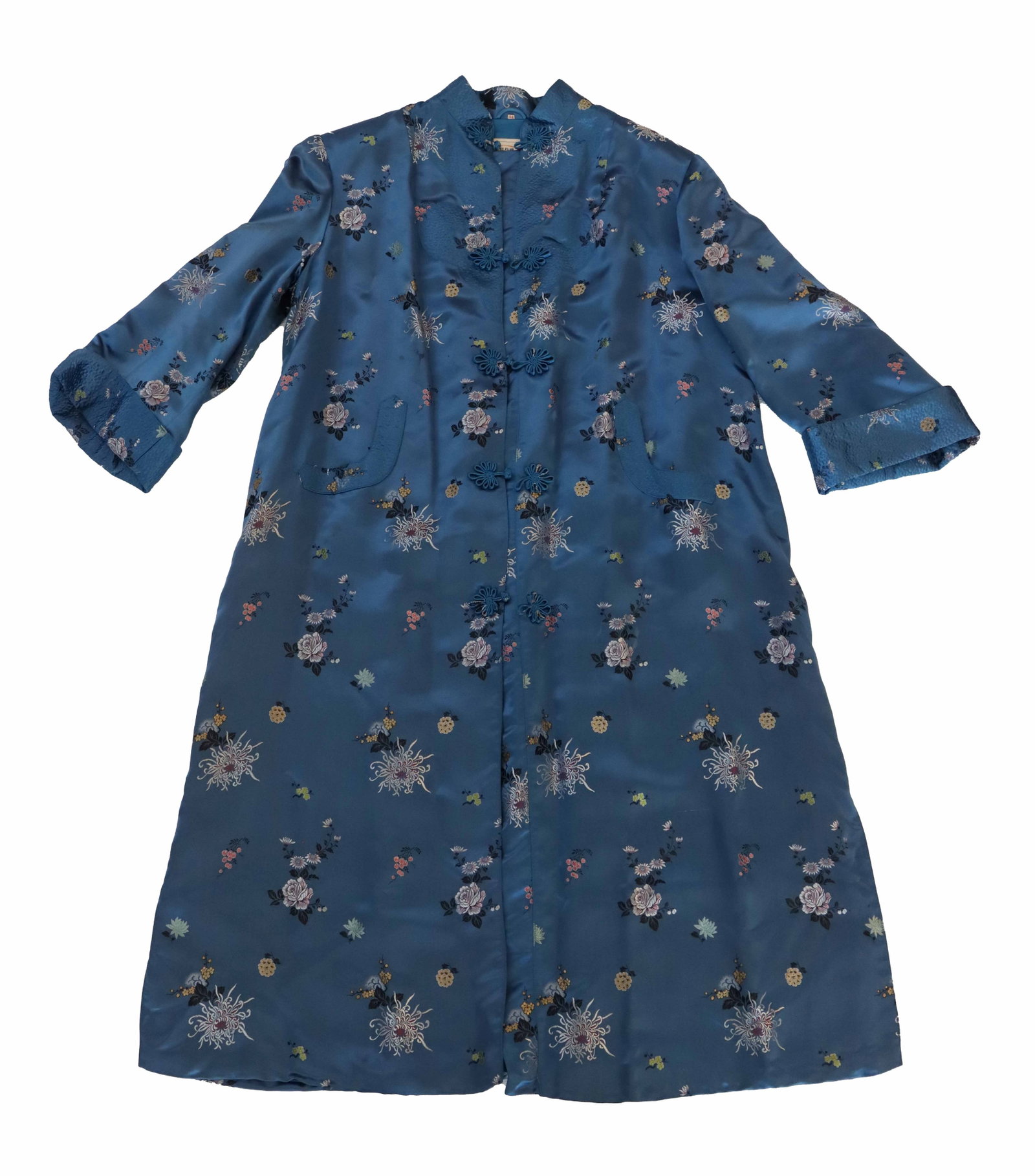 Vintage Chinese Shanghai Peony Satin Robe: Vintage Chinese Shanghai Peony Satin Robe. Vintage blue satin knee-length robe featuring an all-over floral pattern and traditional Chinese-inspired frog closures. Length and Chest: 47 x 29 