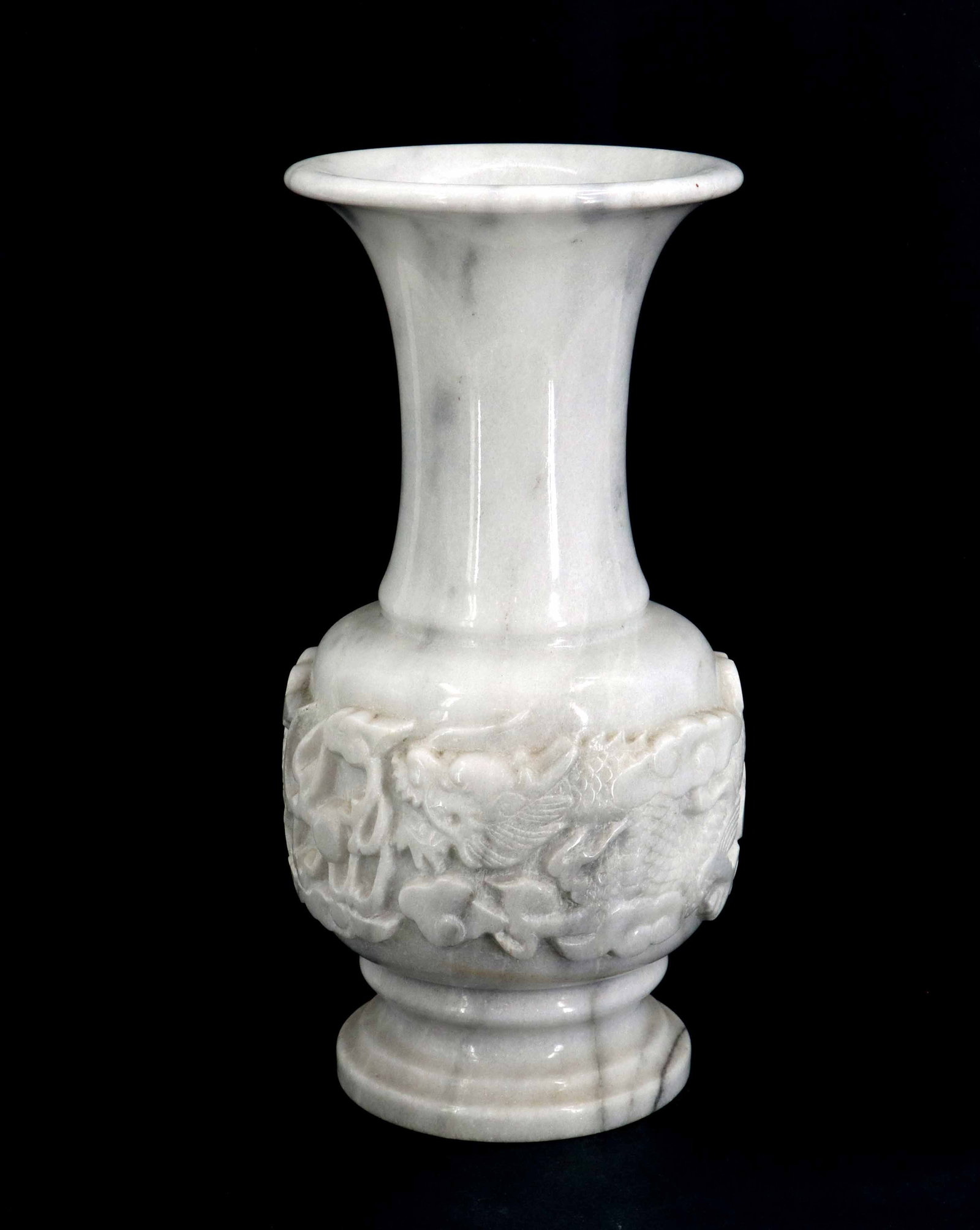 Tall Asian Carved and Polished Marble Vase: Tall Asian Carved and Polished Marble Vase. Formed in an urn shape with an unusually long neck and flared mouth. The image of a dragon soaring among the clouds is prominently raised on the