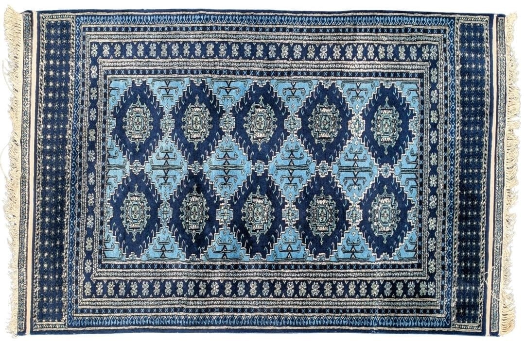 Persian Blue Tribal Bokhara Medallion Oriental Rug: Size: 72 x 48 InchesPersian Blue Tribal Bokhara Medallion Area Rug.The geometric Bokhara design is deeply rooted in the artistic traditions of nomadic Turkmen tribes who historically lived and wove al