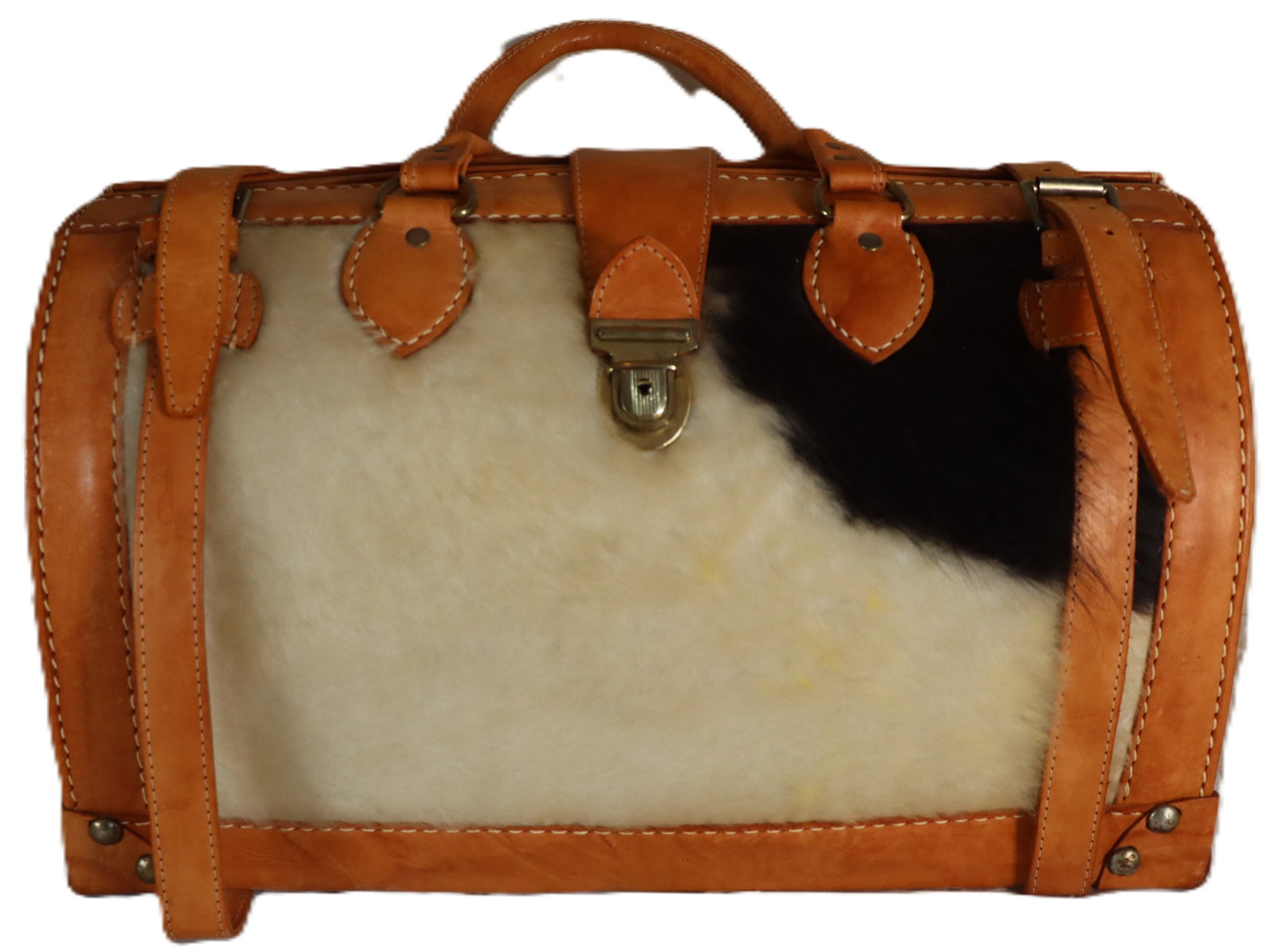 Vintage Style Grants Natural Travel Bag: Vintage Style Grants Natural Travel Bag. Tag on inside. Crafted from structured tan leather accented with striking cowhide or sheepskin body in cream and black. The rustic design features a robus