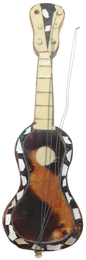 Miniature Natural Shell Guitar - AS IS: Miniature Natural Shell Guitar - AS IS. Guitar figurine with mother-of-pearl accents. Condition: Two strings unstrung. Size: 1 1/2 x 1/2 x 5 in. 