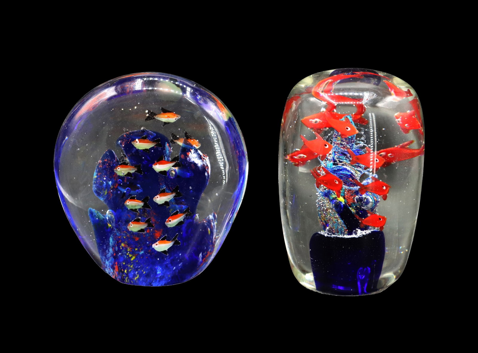(2) Vintage Hand Blown Art Glass Aquariums: (2) Vintage Hand Blown Art Glass Aquariums. Two clear glass aquarium paperweights containing colorful, multi-layered internal scenes of bright orange fish swimming around textured, cobalt blue coral r