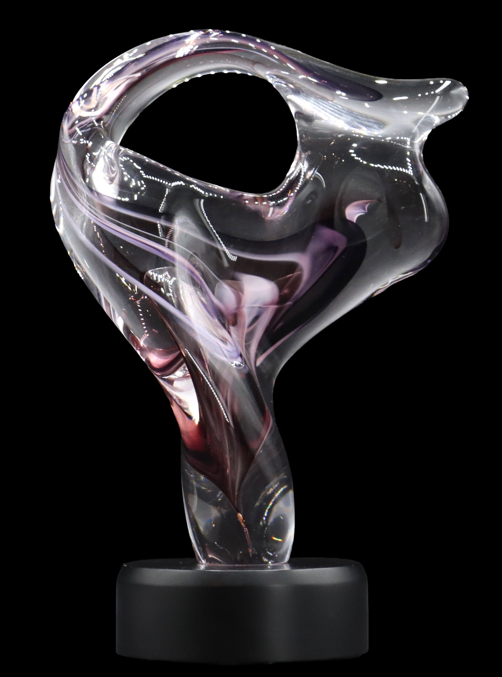 David Goldhagen (Born 1957) American, Art Glass Sculpture with Light-Up Stand: David Goldhagen (Born 1957) American, Art Glass Sculpture with Light-Up Stand. The flowing form with an opening up top has mostly purple hues streaked throughout. Signed and dated 2/92 near the b