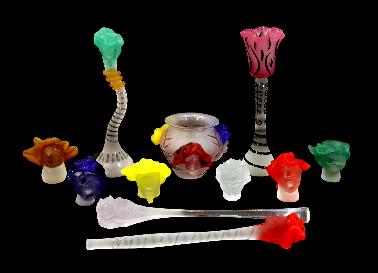 (11) Studio Art Glass Sculptures: (11) Studio Art Glass Sculptures. Vibrant collection of whimsical studio art glass features two tall, slender vases with patterned stems, a central frosted bowl accented with colorful handles, and an 
